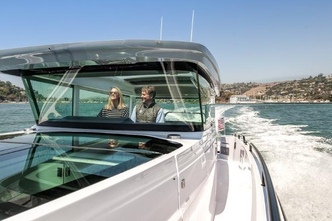 2027 Axopar 37 XC Cross Cabin cruising on open water with two passengers onboard.