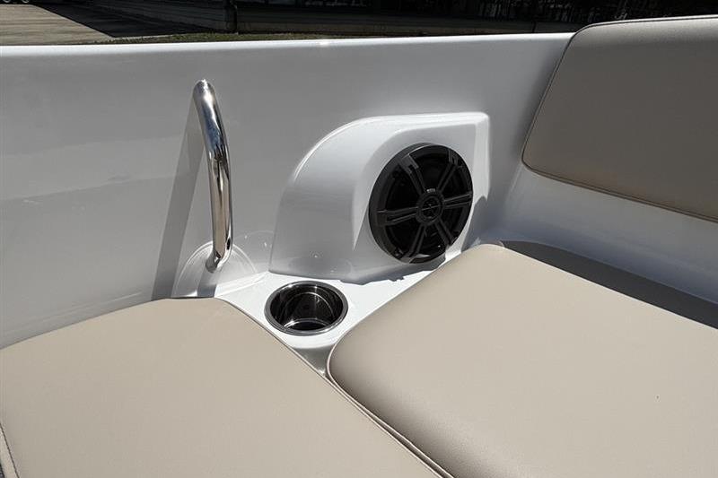 Interior of 2026 Tahoe 2150 boat featuring speaker, cup holder, and beige seating.