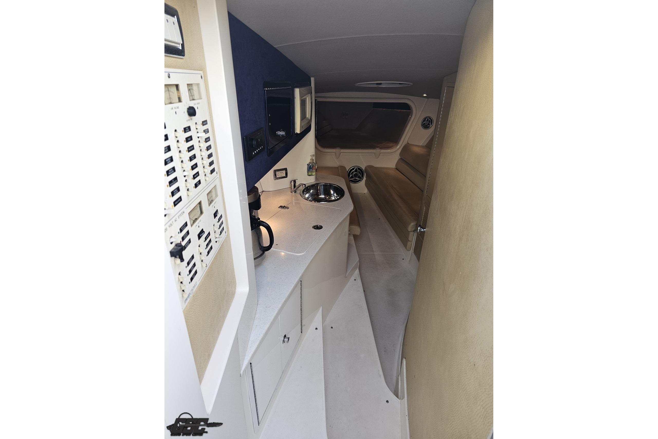 2007 Hustler 41 Razor cabin interior with control panel, sink, and seating area.