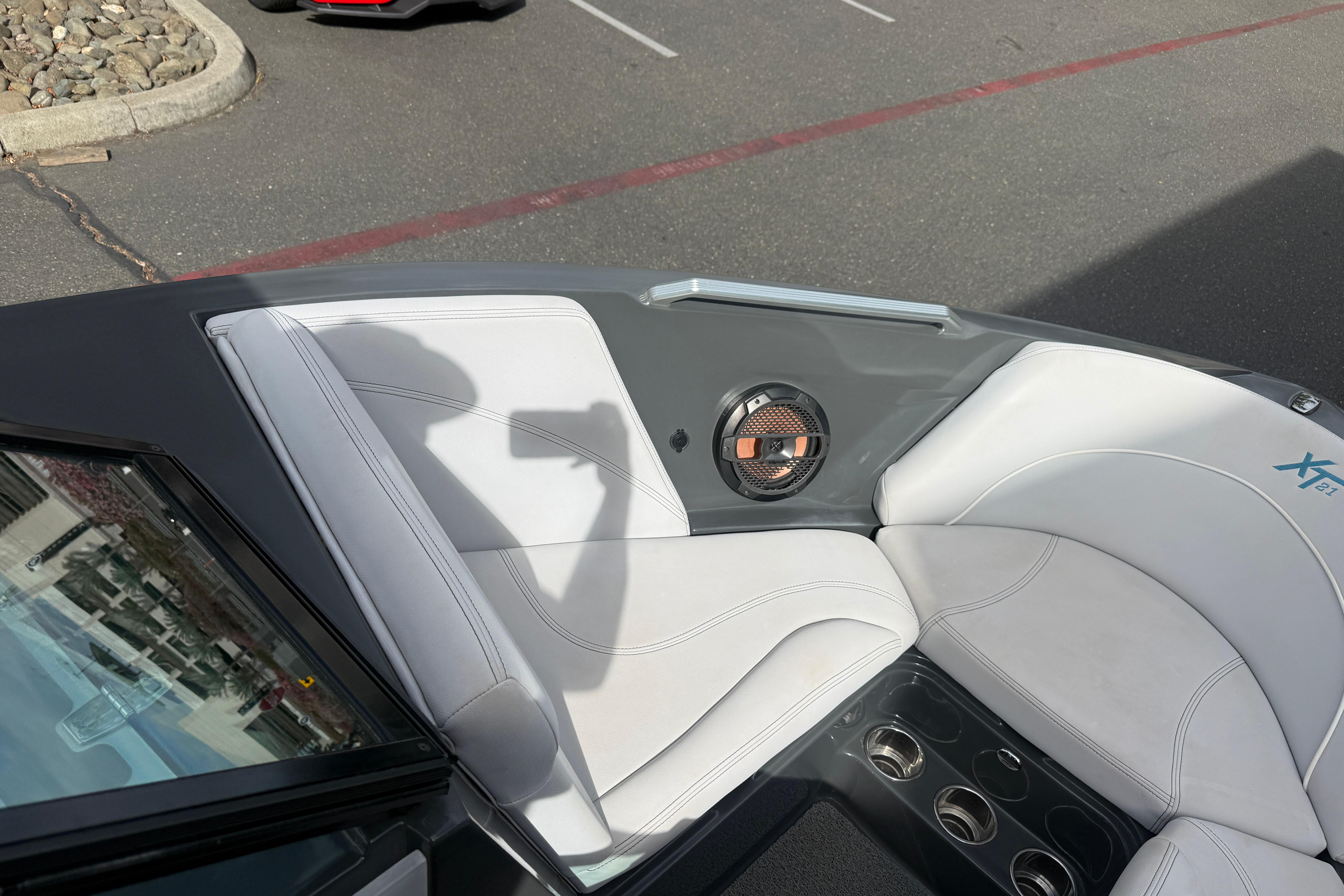 2018 MasterCraft XT21 boat interior with white seating and speaker detail.