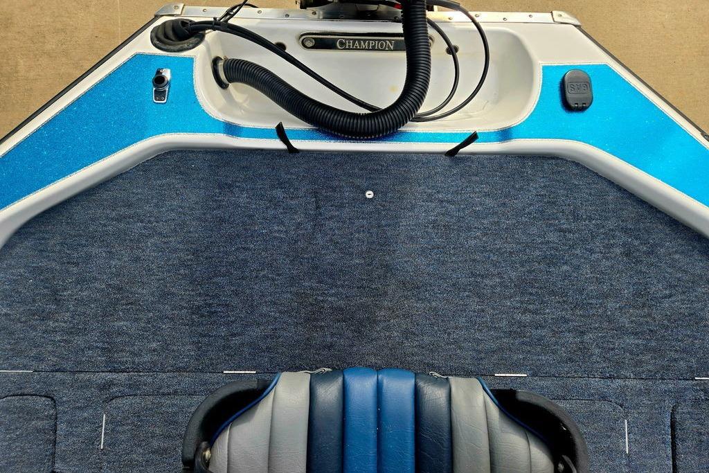 1996 Champion 181 SX boat interior with blue carpet and seating.