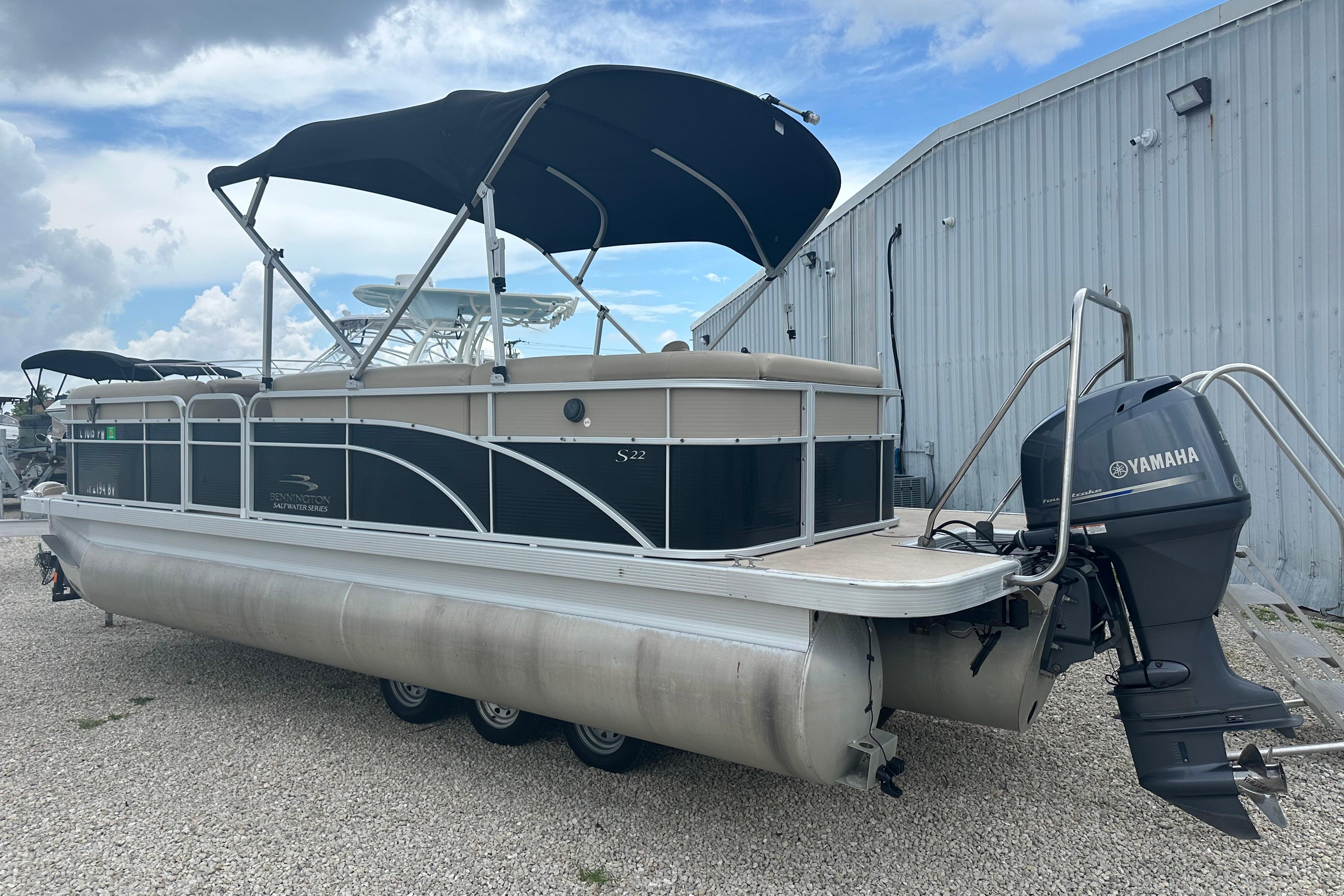 2014 Bennington S22 pontoon boat with Yamaha outboard motor, parked outdoors.