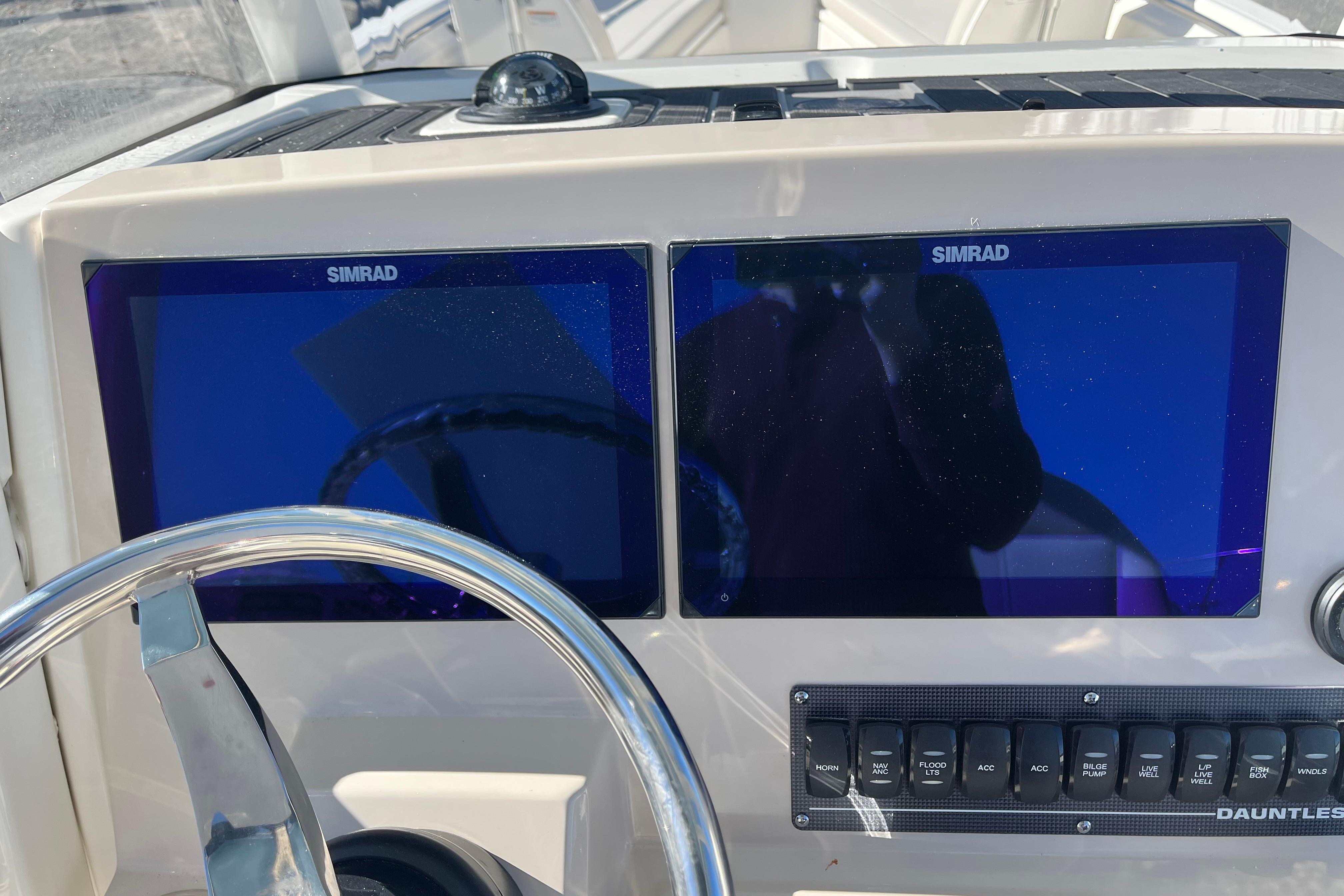 Helm of 2026 Boston Whaler 280 Dauntless with Simrad displays and control panel.