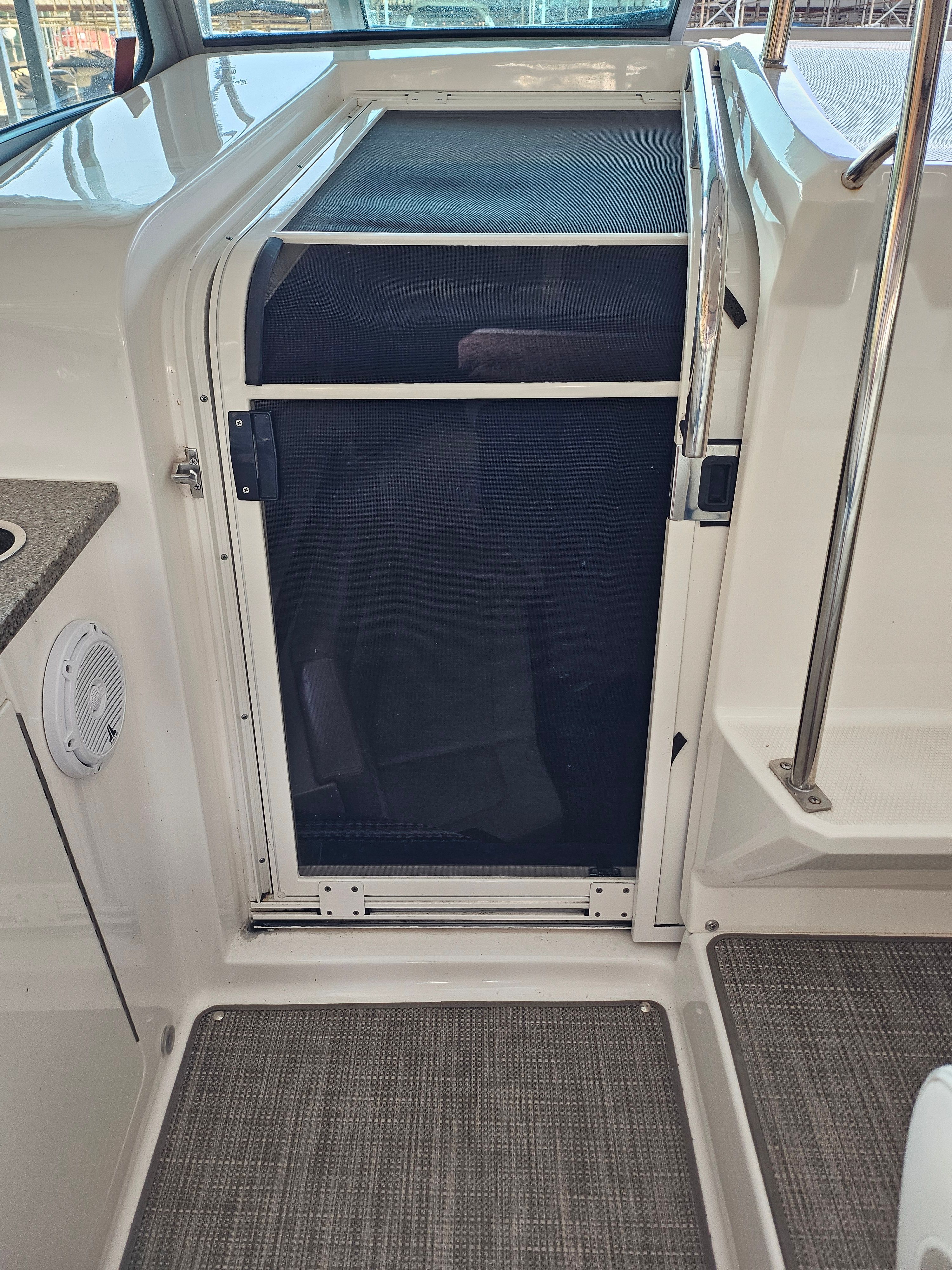 Interior of 2014 Chaparral 330 Signature with door and carpet flooring.