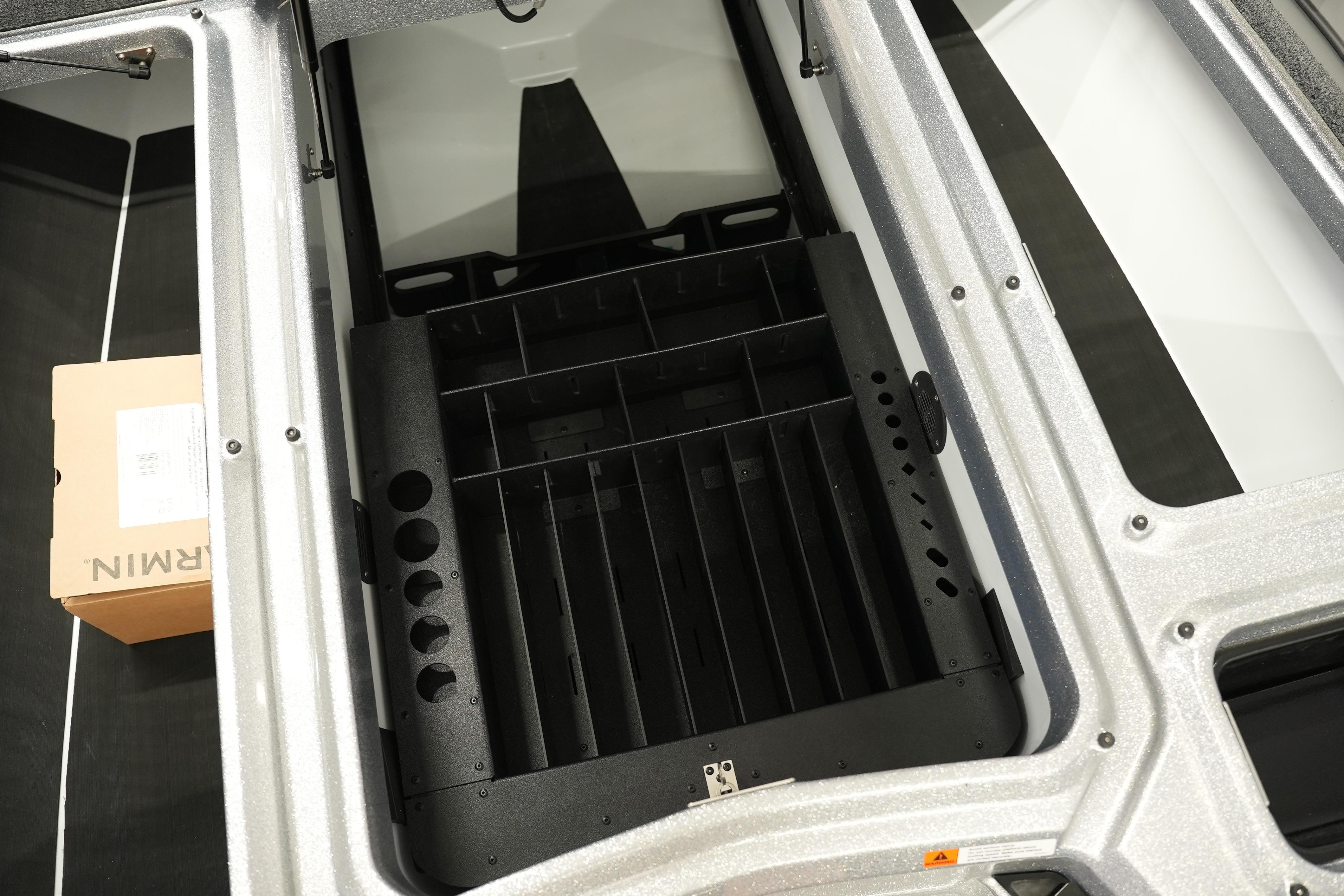 Interior view of 2026 iKon LXE20 storage compartment with organized sections and a cardboard box.