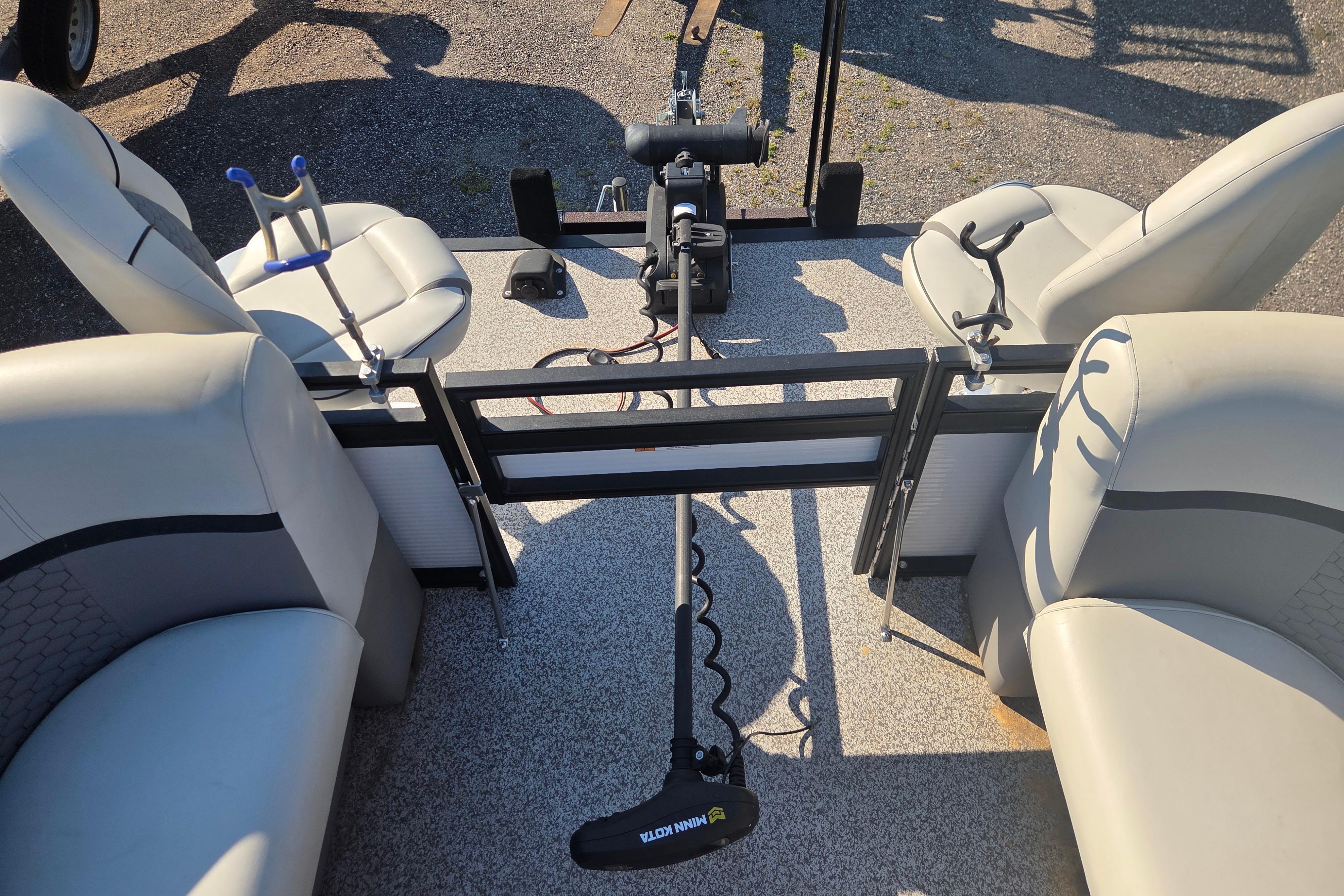 2024 Angler Qwest 8526 Pro Troll boat interior with seating and trolling motor.