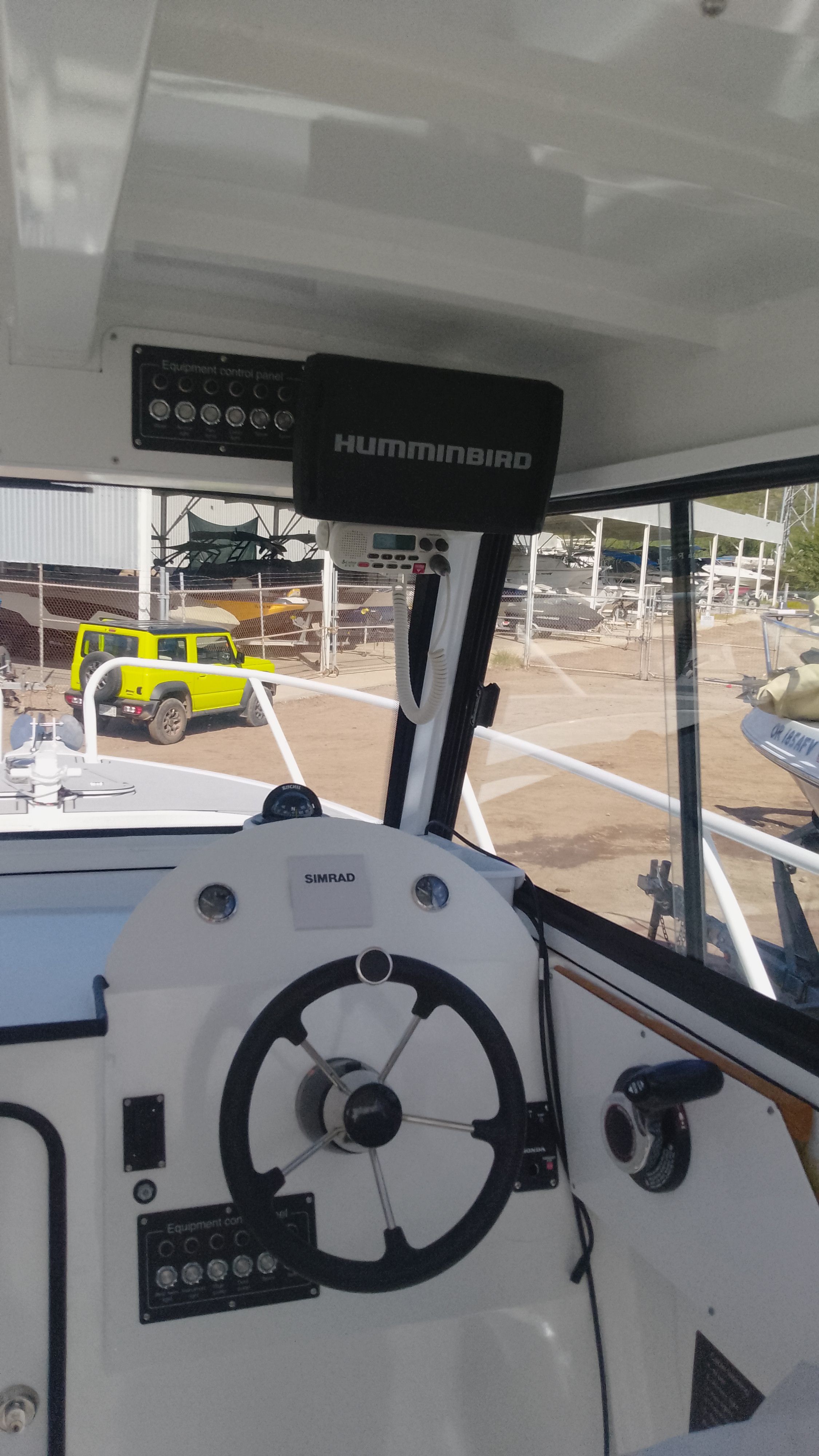 Interior view of Gospel Boat 7.5M 2024 with steering wheel and electronics.