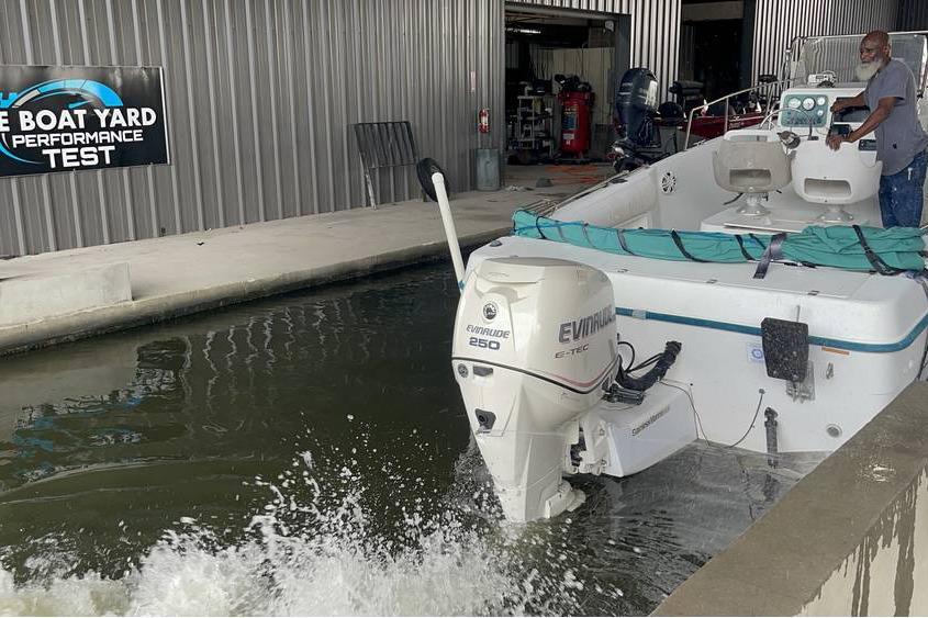1998 Sunbird 230 CC boat undergoing performance test at a boat yard facility.