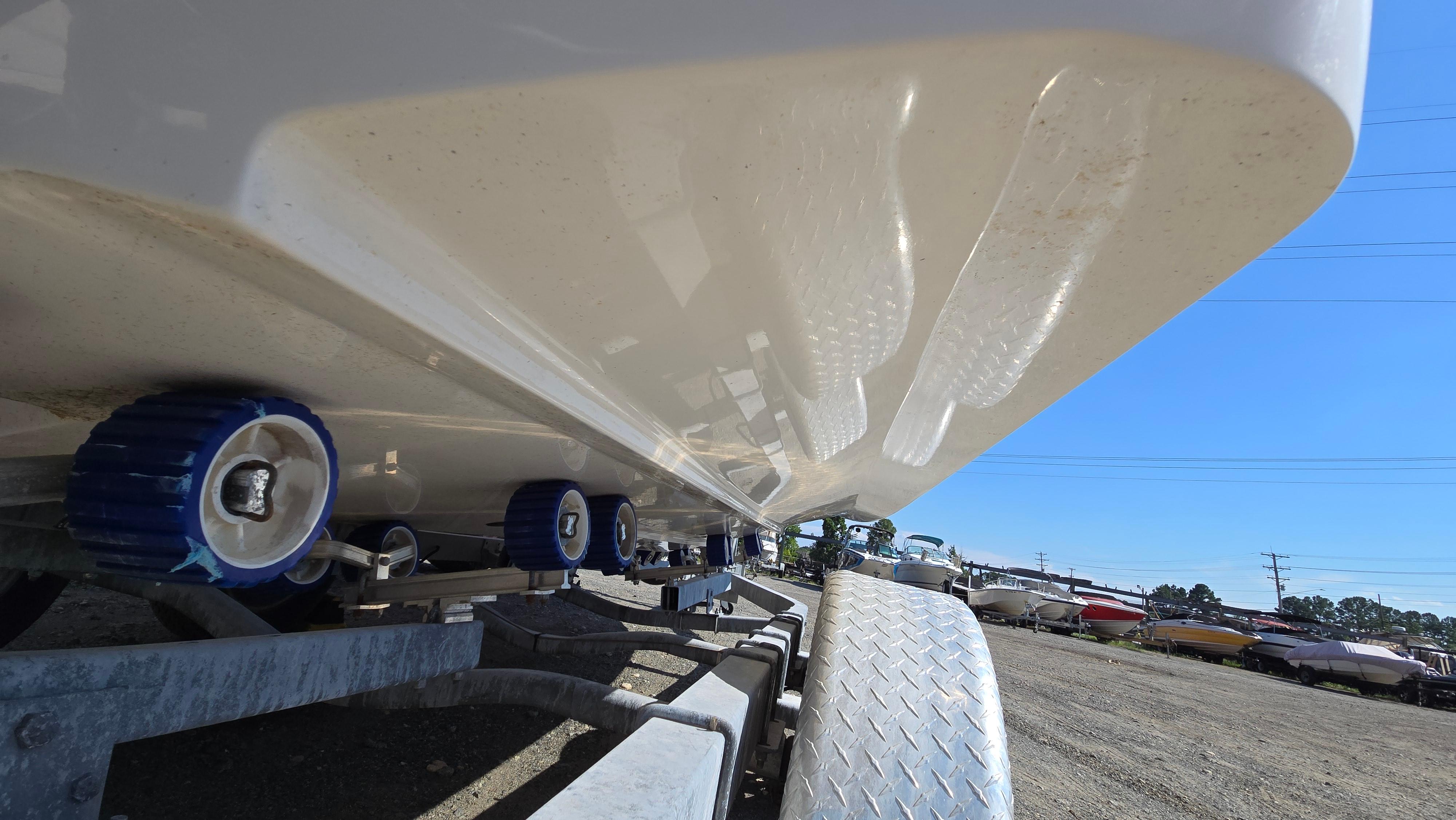 2018 Chaparral 224 Sunesta boat on trailer, close-up view of hull and rollers.