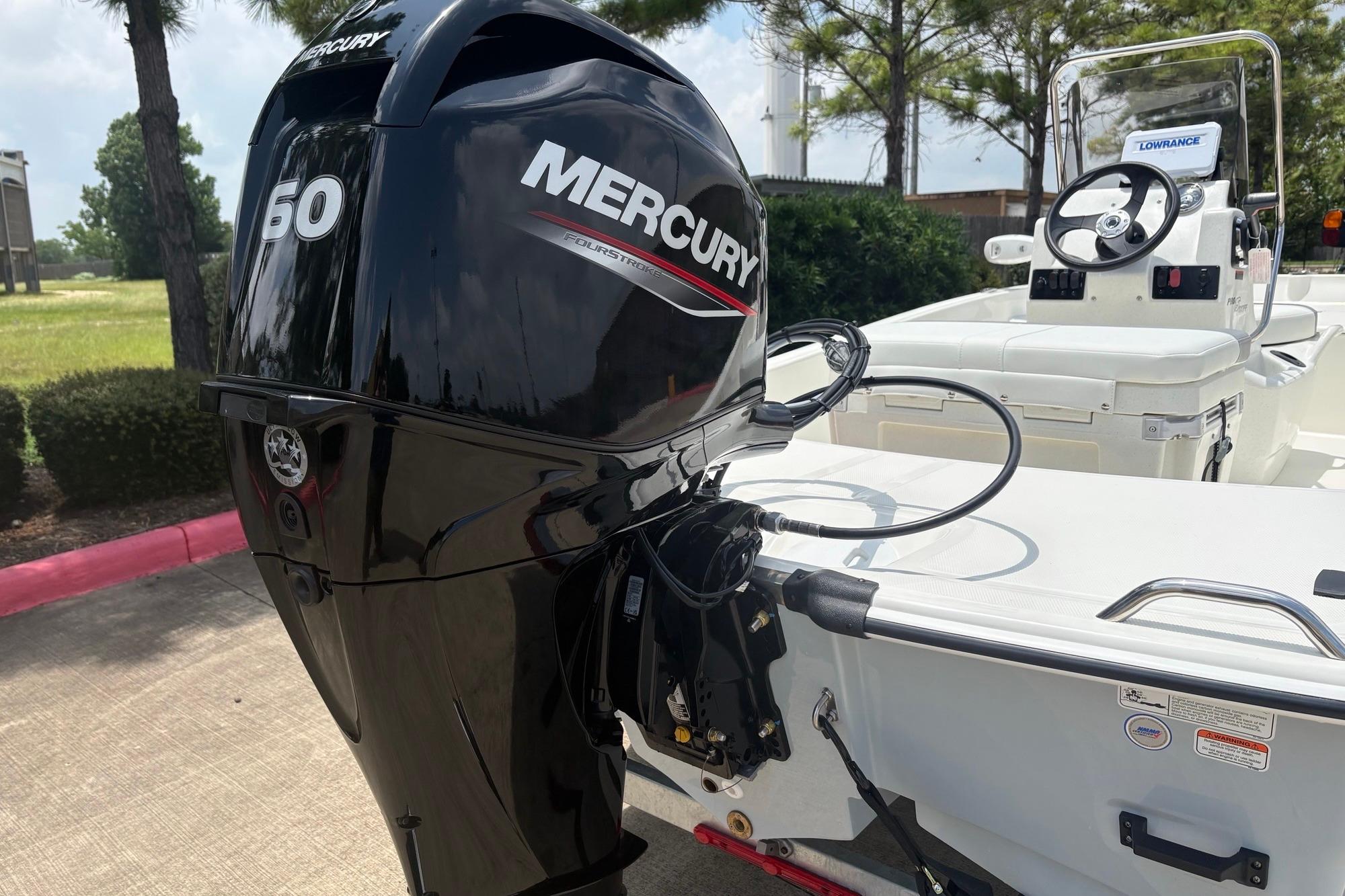 2026 Mako Pro Skiff 15 CC with Mercury 50 outboard motor, parked outdoors.