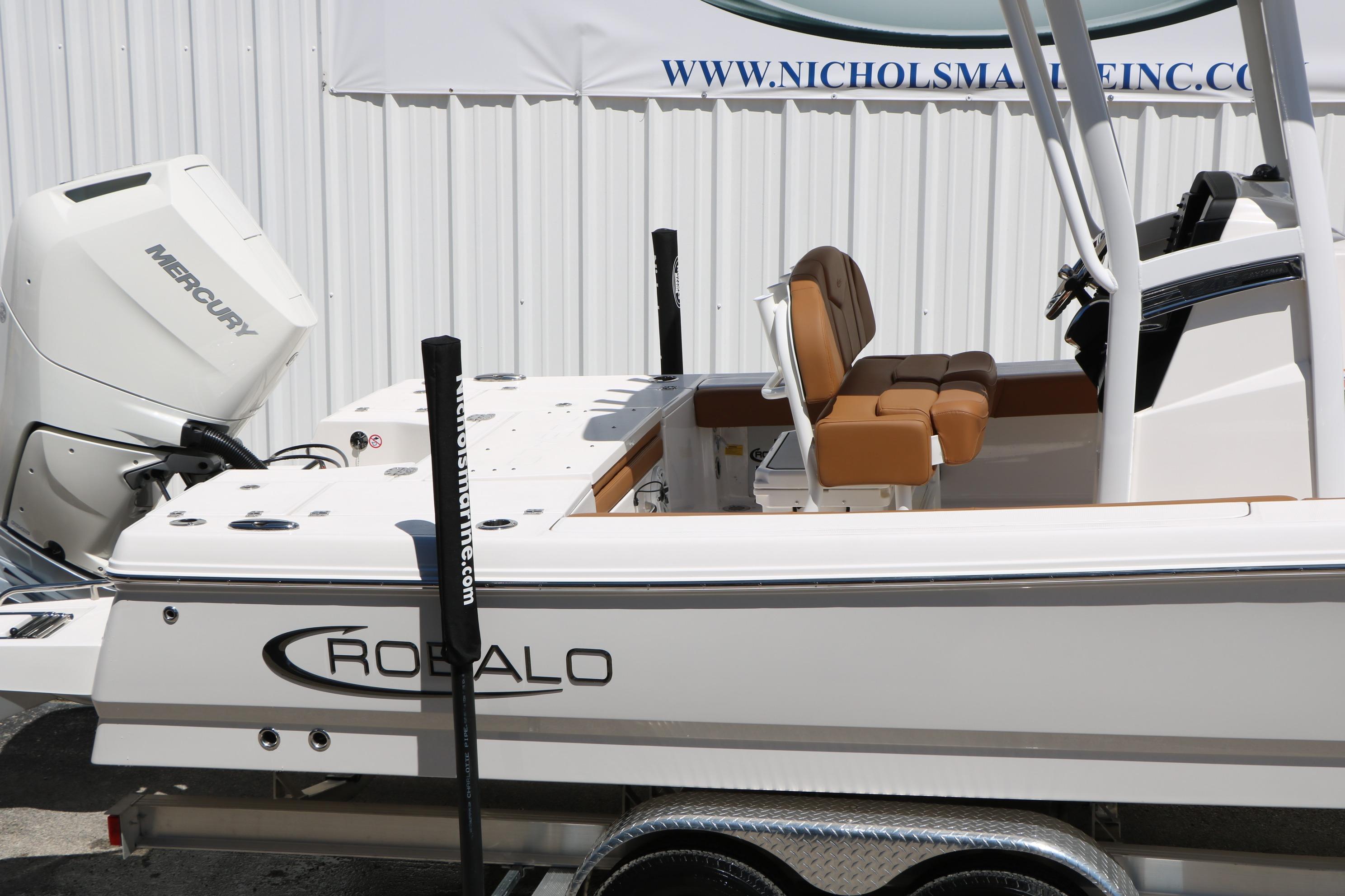 2026 Robalo 246 Cayman boat with Mercury engine, displayed on trailer.