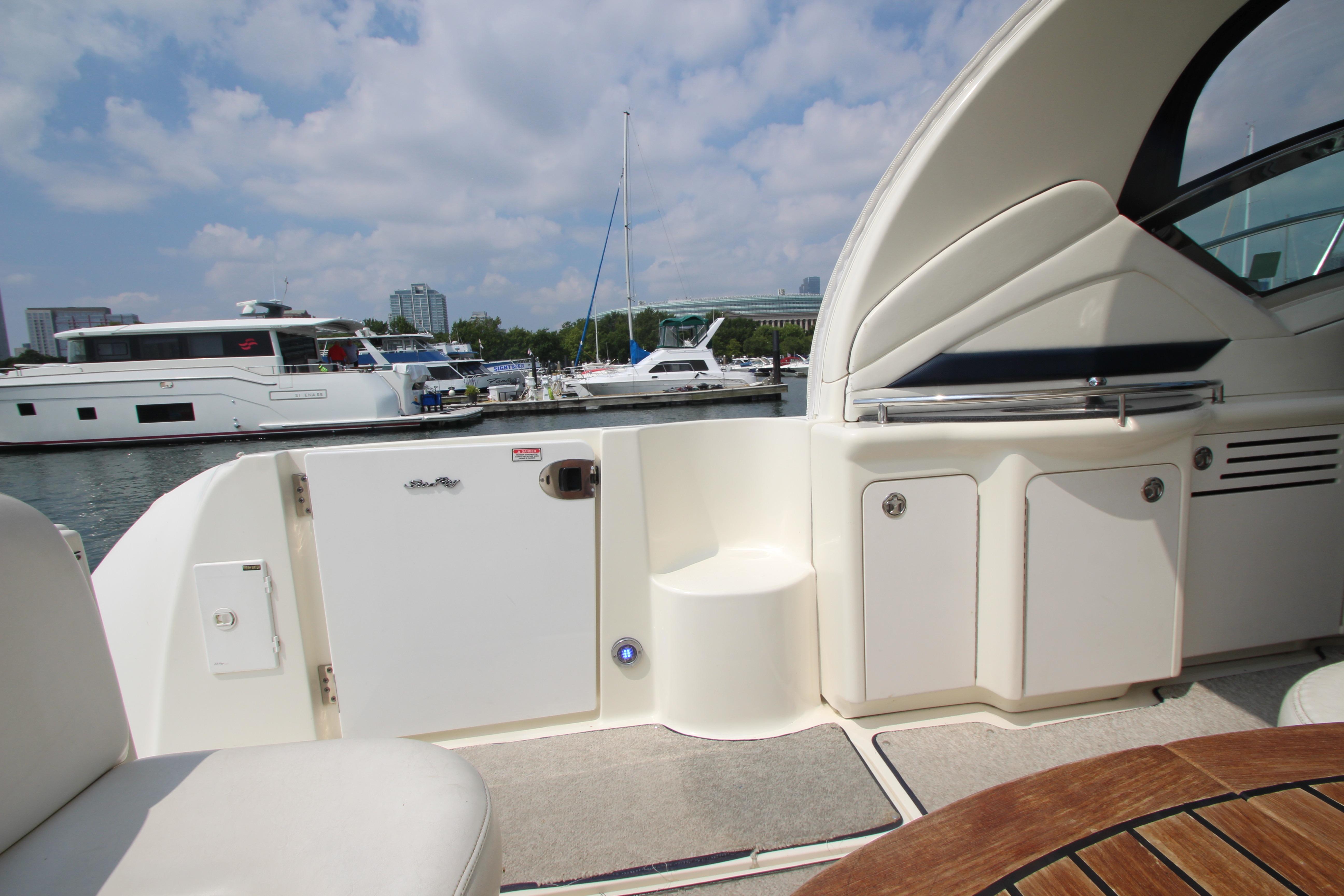2004 Sea Ray 40 Sundancer yacht interior with marina view, featuring seating and storage.
