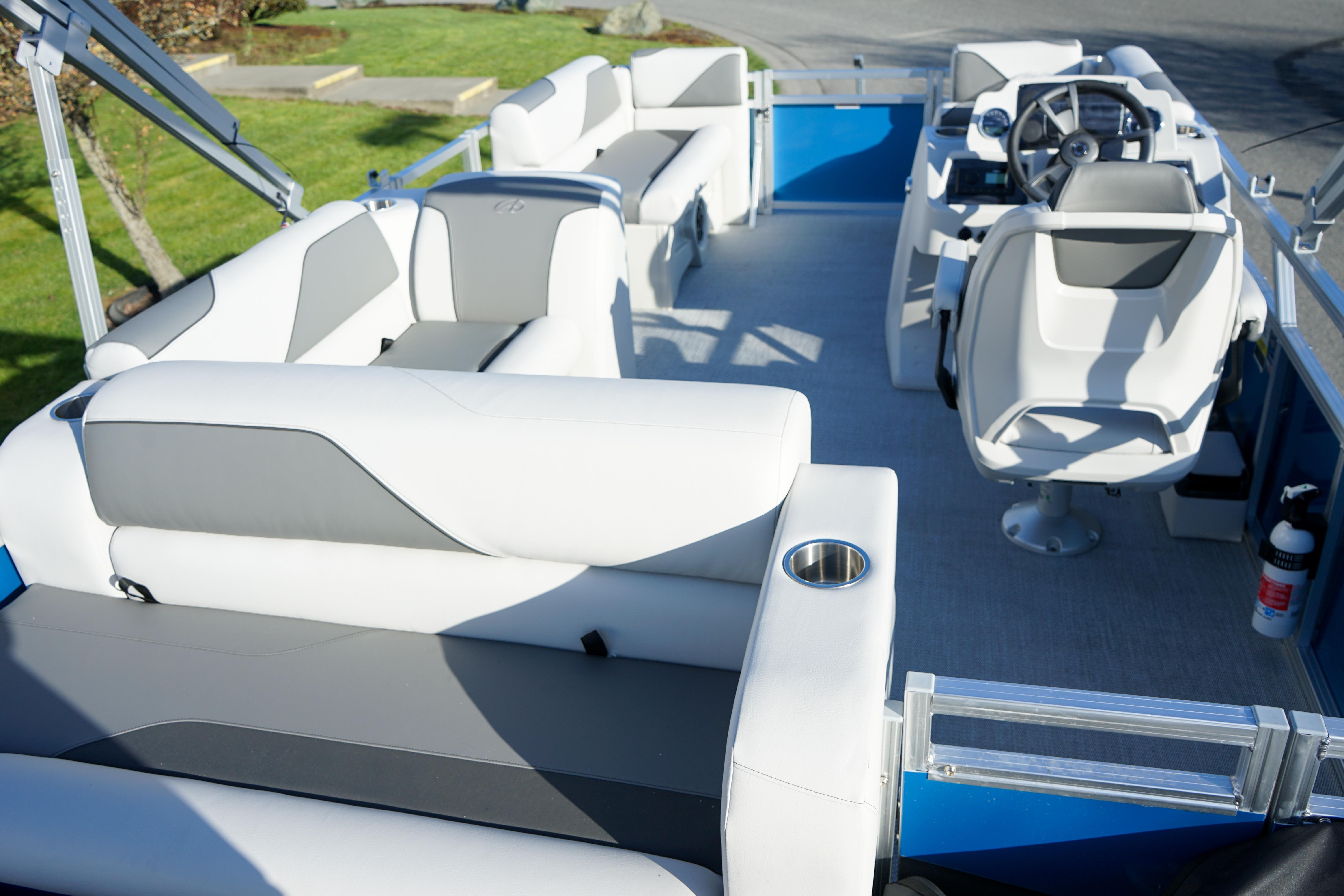 2024 Avalon 17 Venture Cruise pontoon boat interior with white seating and steering console.