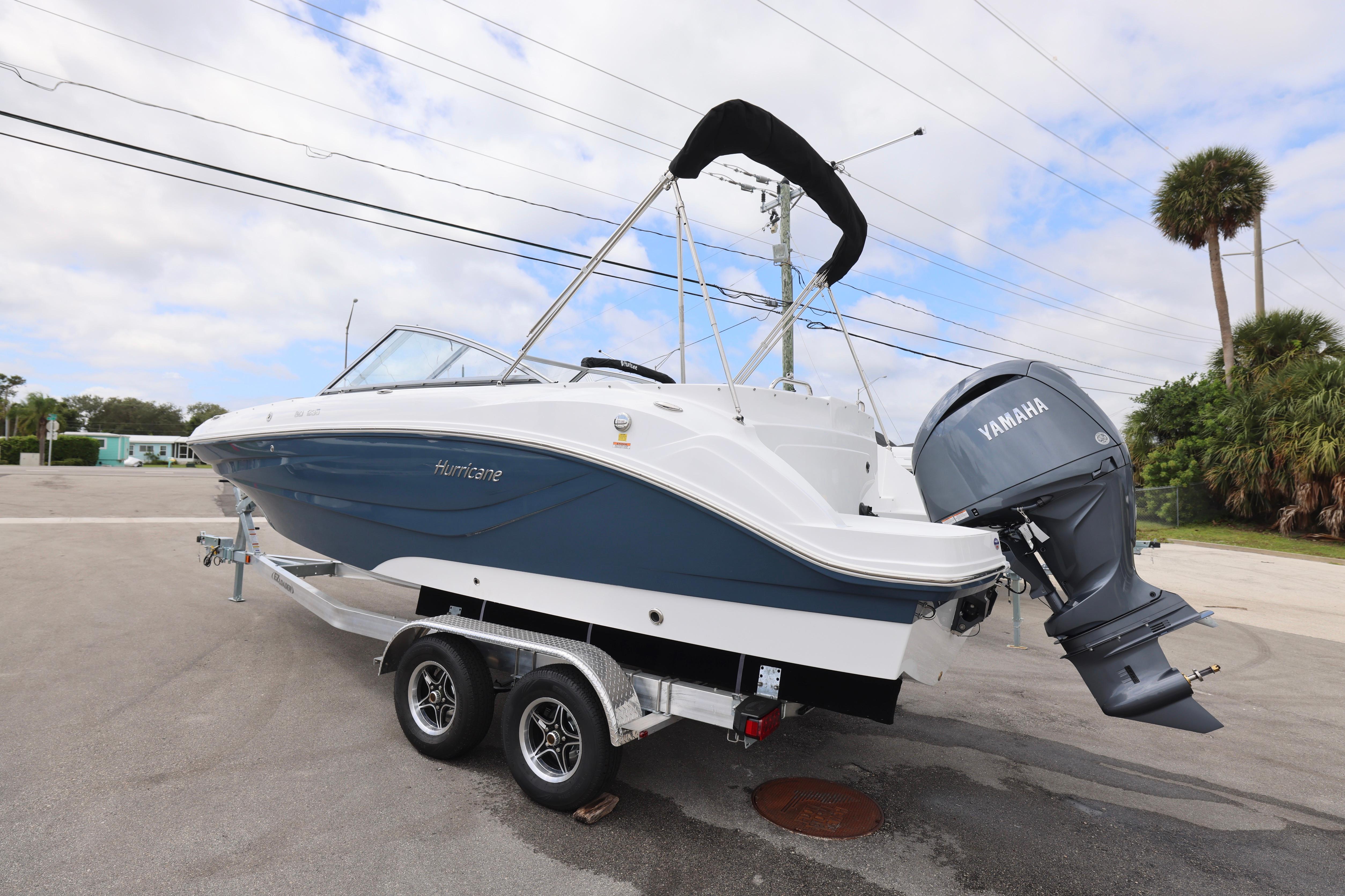 2026 Hurricane SunDeck 235 OB boat on trailer with Yamaha outboard motor.