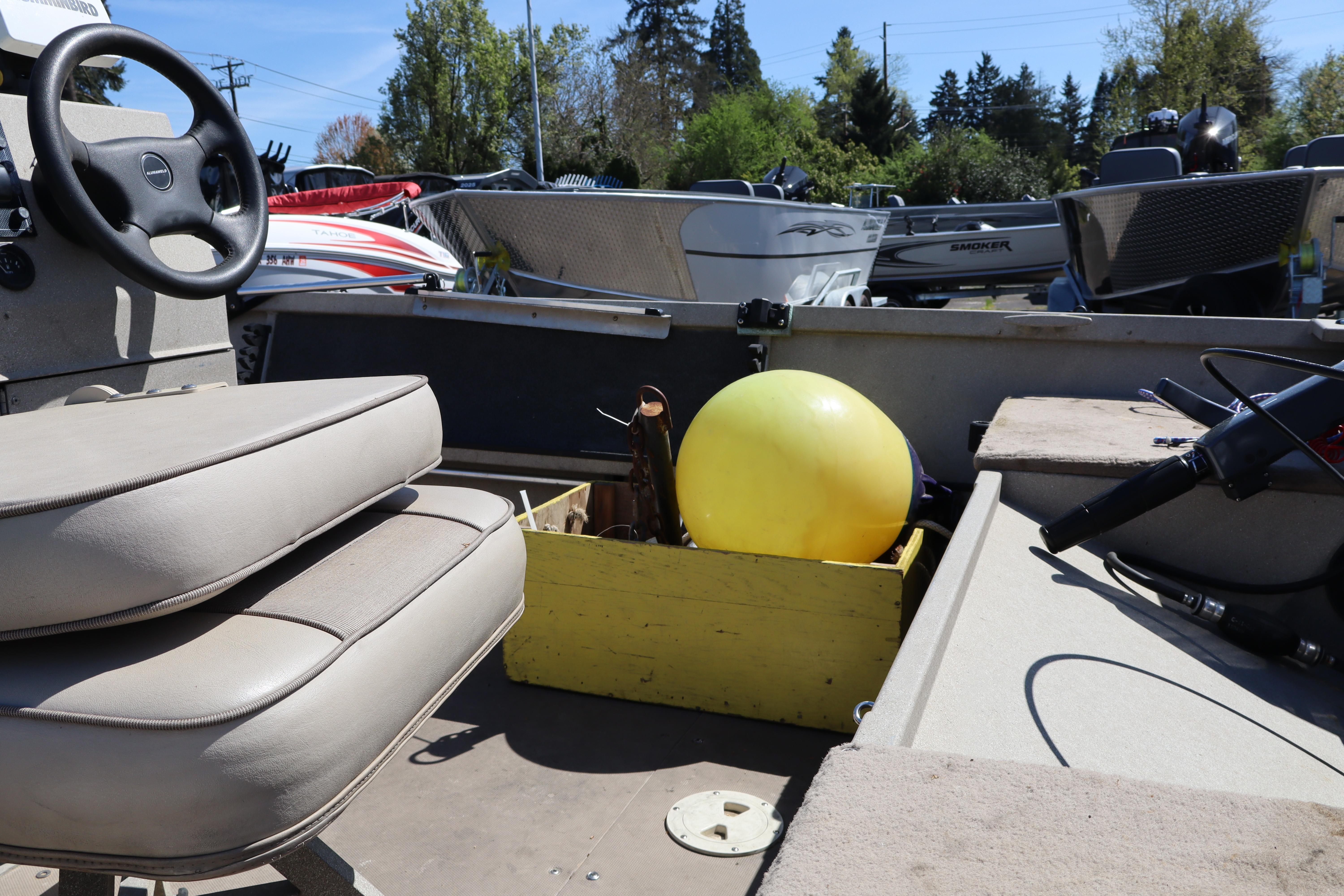 Interior of a 2002 Alumaweld SUPER VEE LS boat with steering wheel and yellow buoy.