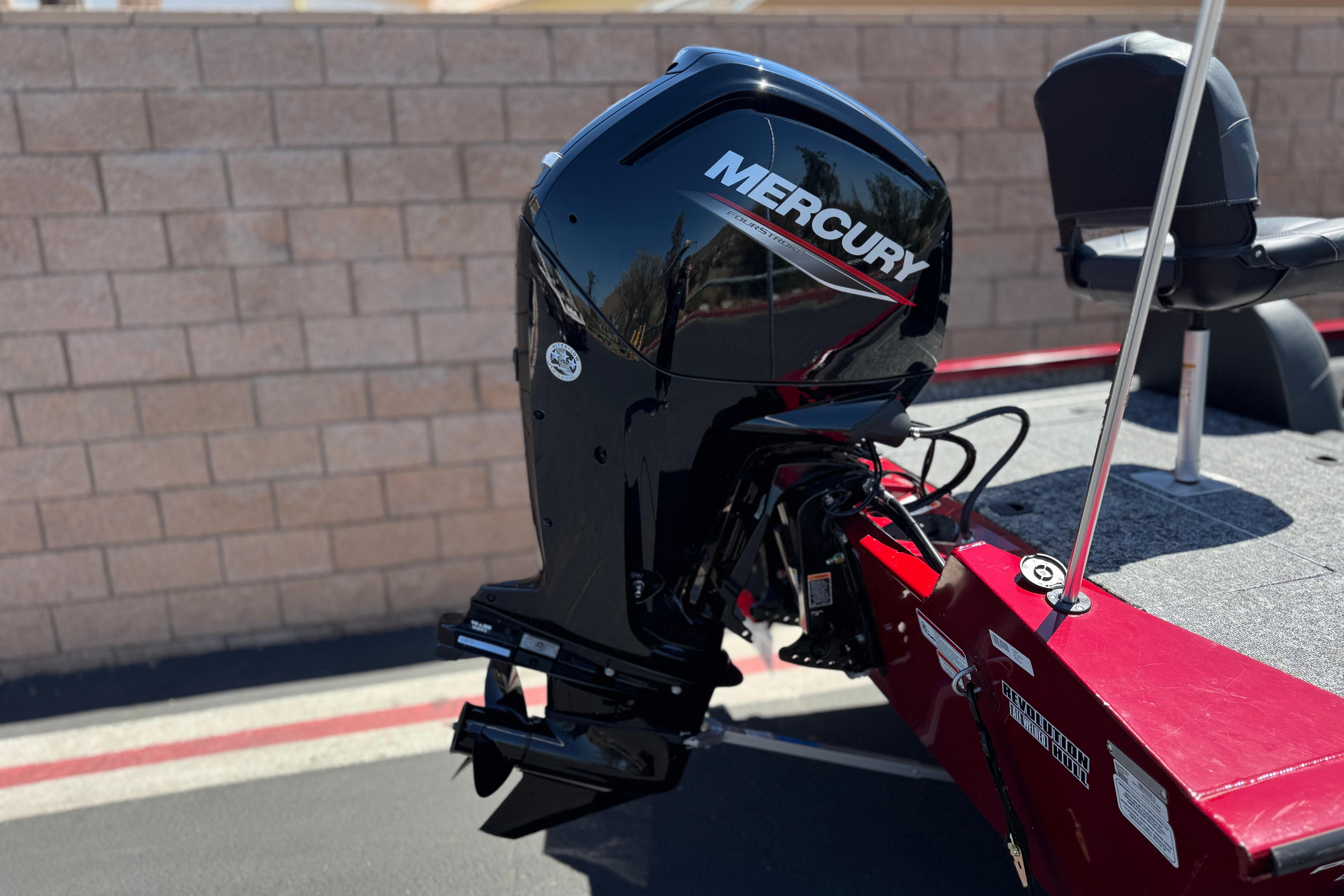 2025 Tracker Pro Team 175 TXW boat with Mercury outboard motor, parked near a brick wall.