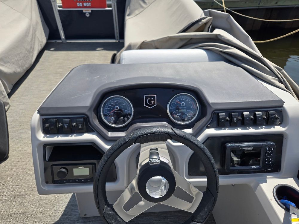 The image shows the helm of a 2022 Godfrey Sweetwater 2186C with instruments and controls.