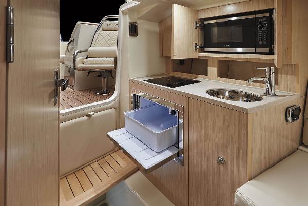 Interior of 2021 Chris-Craft Corsair 34 with kitchen and seating area.