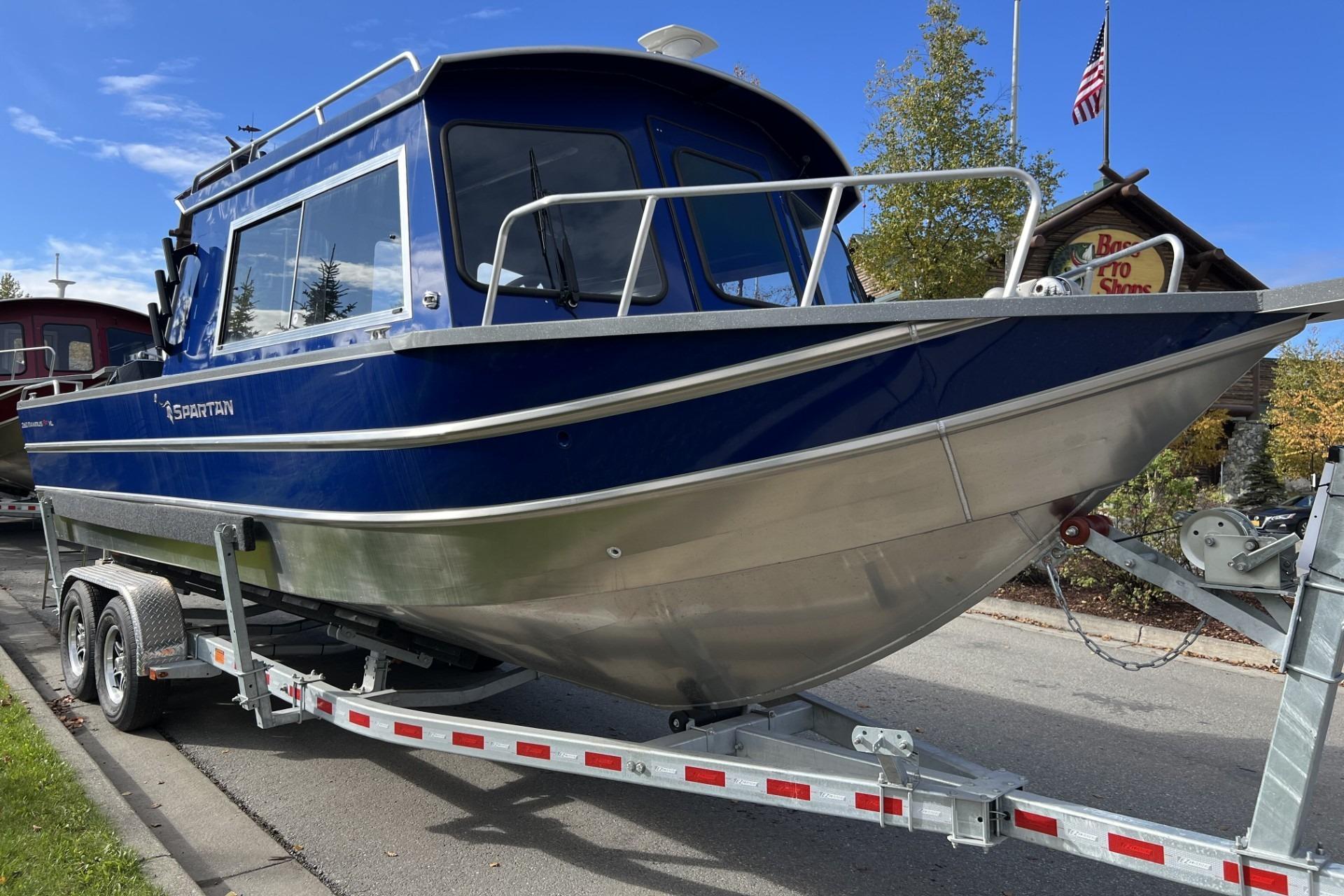 2024 Spartan 26 Maximus Pro XL boat on trailer, parked outdoors.