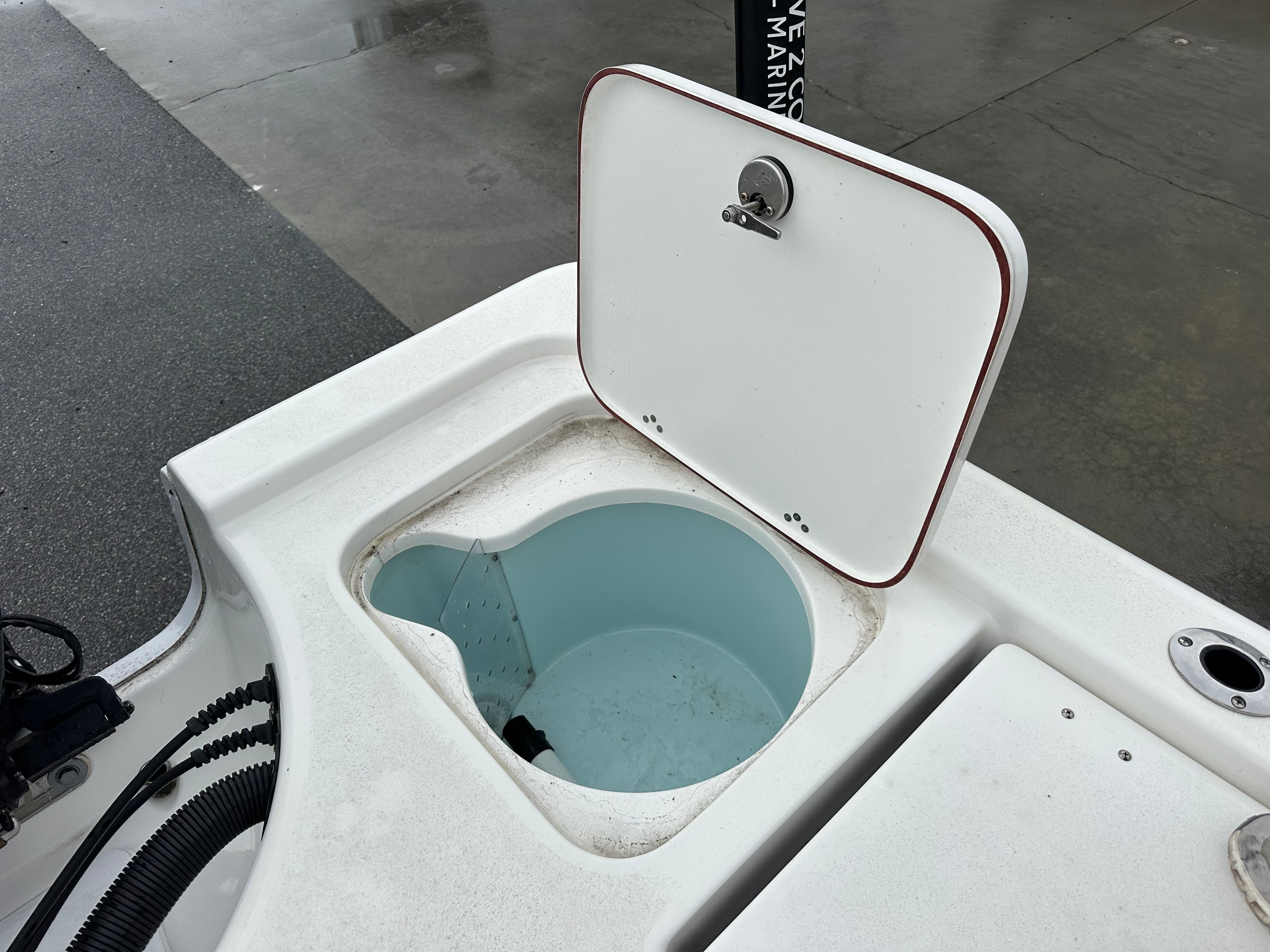 An open storage compartment on a 2025 Sea Pro 230 DLX boat.