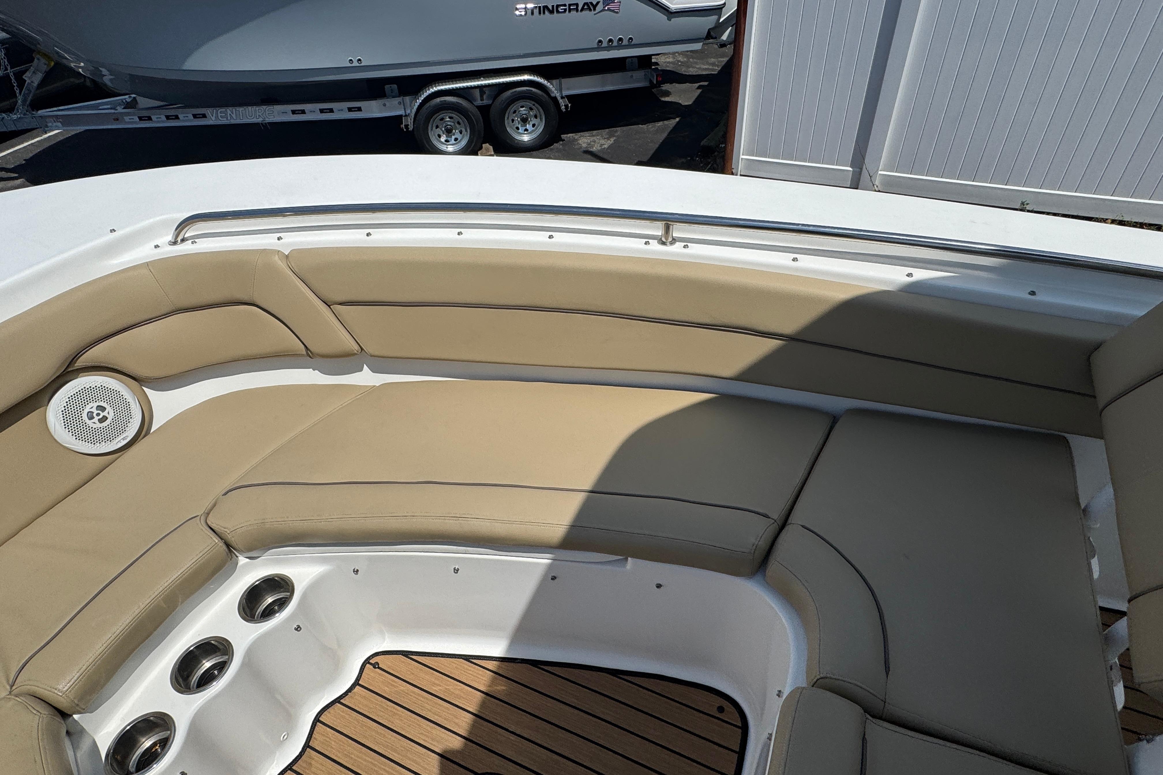 2016 Tidewater 230 LXF boat interior with tan seating and cup holders.