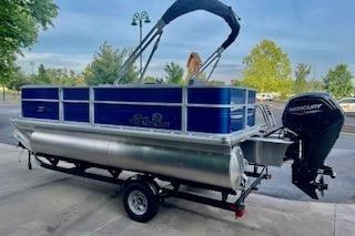 2026 Sun Tracker Party Barge 18 DLX pontoon boat with Mercury engine on trailer.
