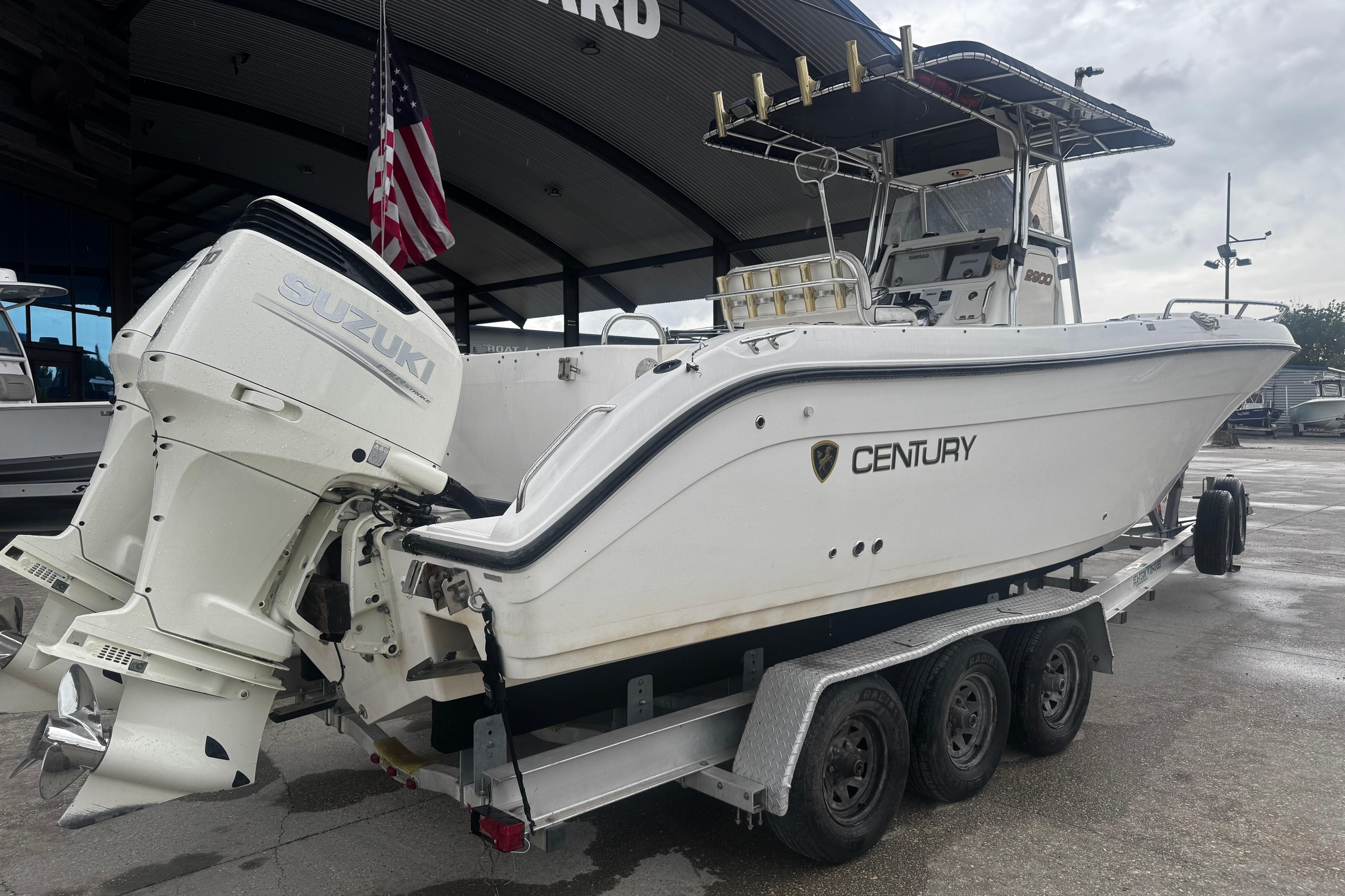 2004 Century 2900 Center Console boat with Suzuki engines on a trailer.