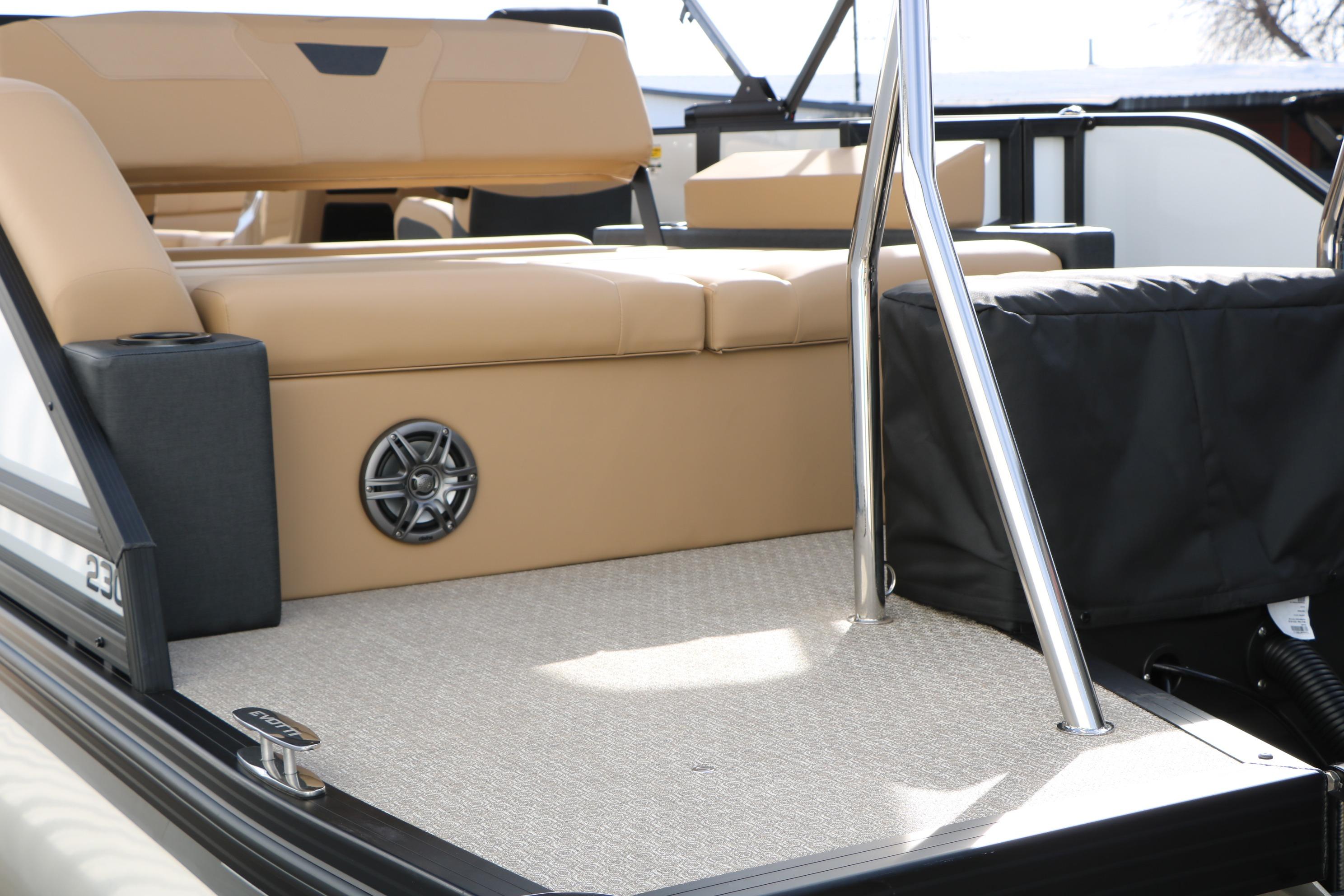 Luxury seating on 2026 Evotti 523CS boat with speaker and stainless steel railing.