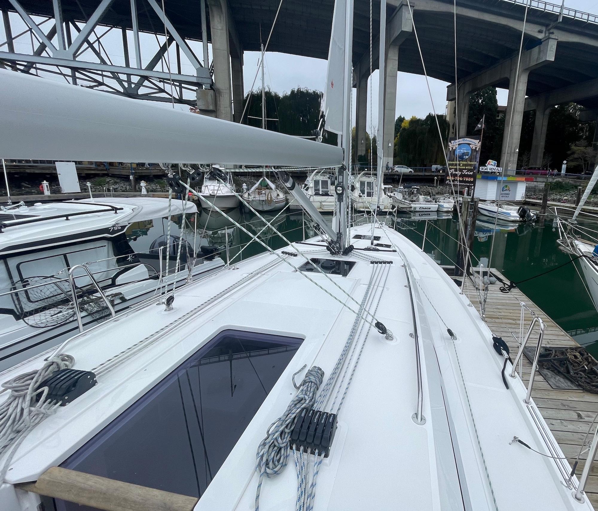 2023 Bavaria C 38 sailboat docked at marina under bridge.