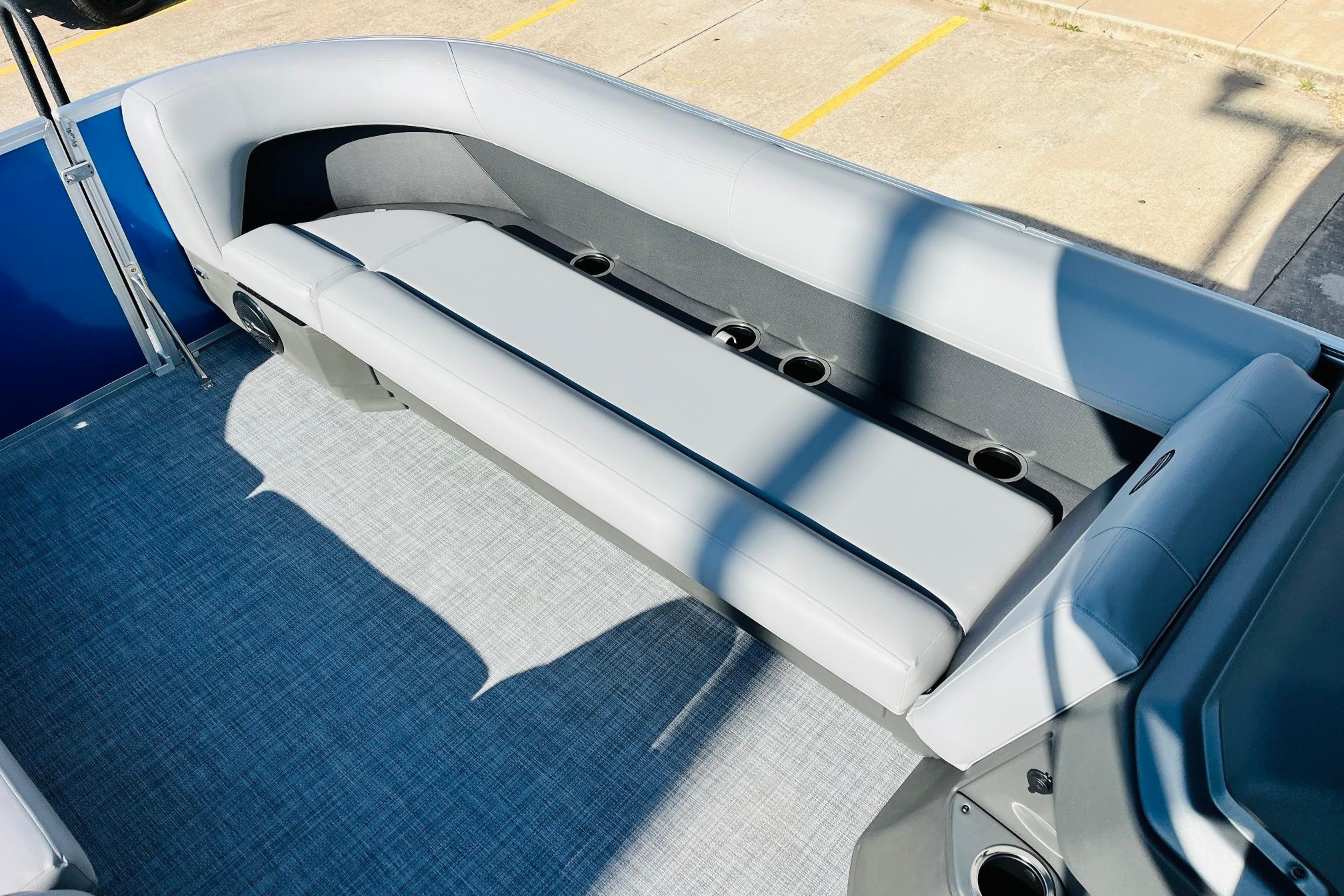 2026 Sun Tracker Party Barge 18 DLX interior with gray seating and cup holders.
