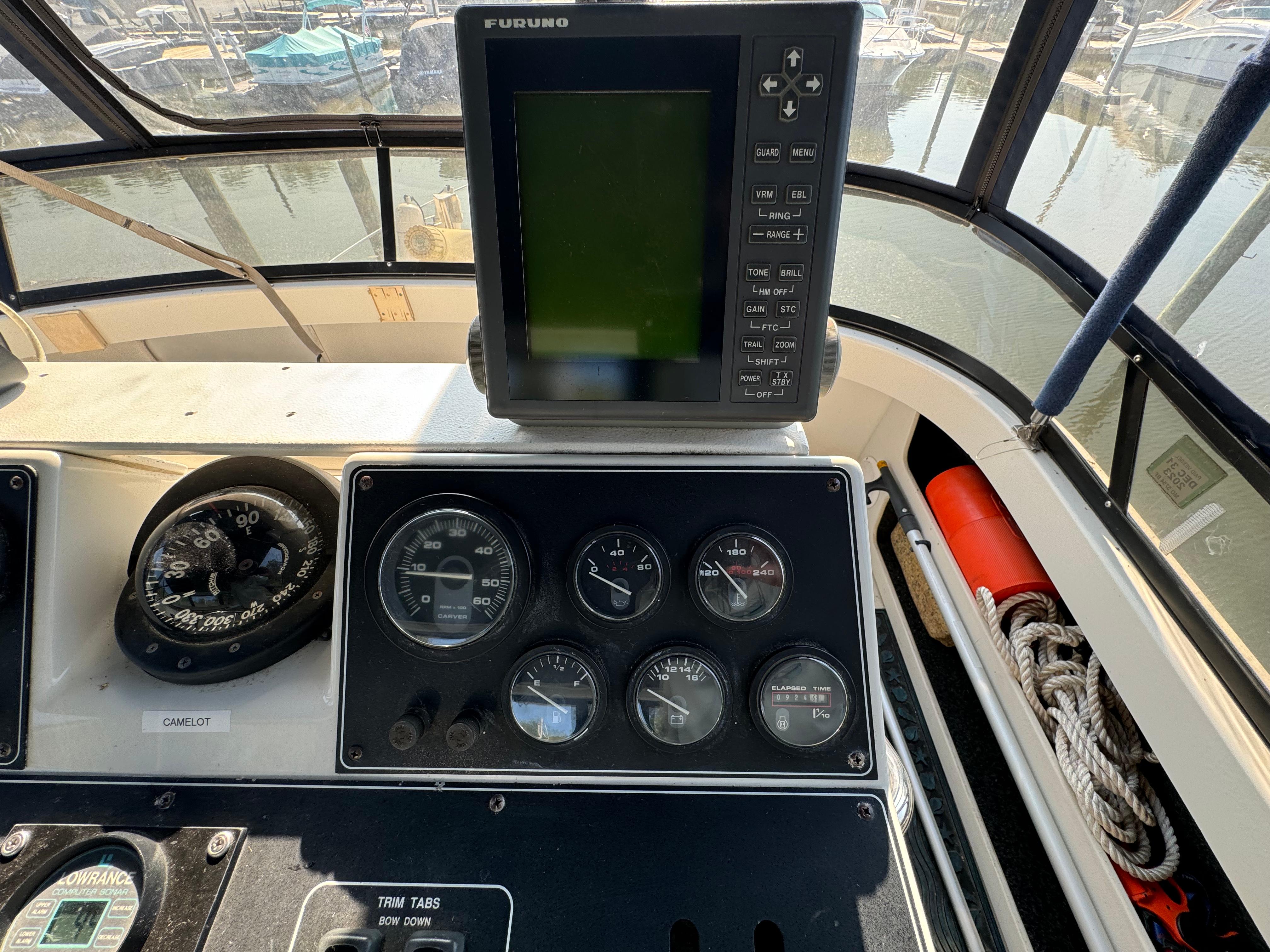 Control panel of a 1991 Carver 33 Aft Cabin with navigation equipment and gauges.