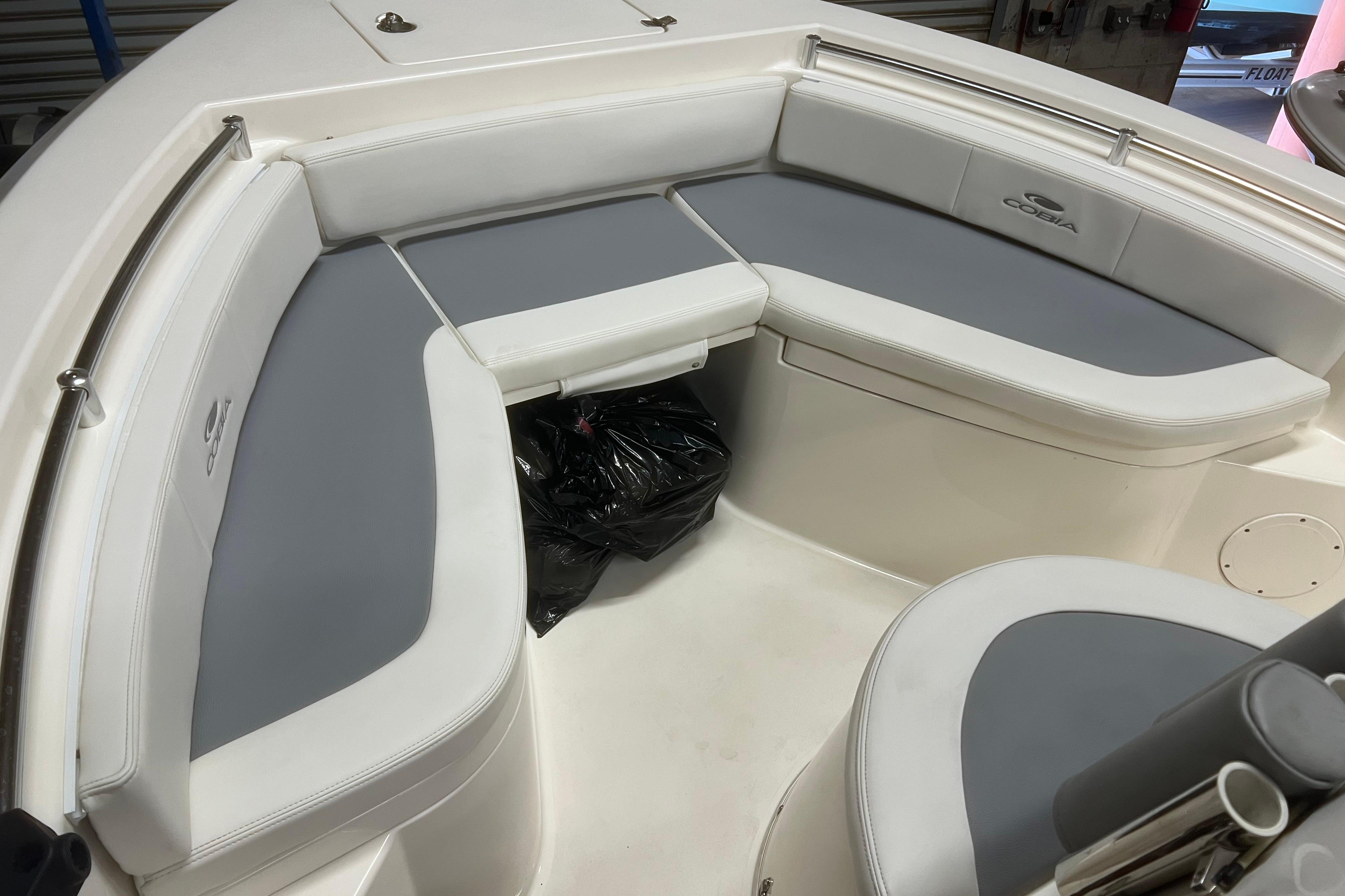 2018 Cobia 201 Center Console boat interior with cushioned seating and storage.