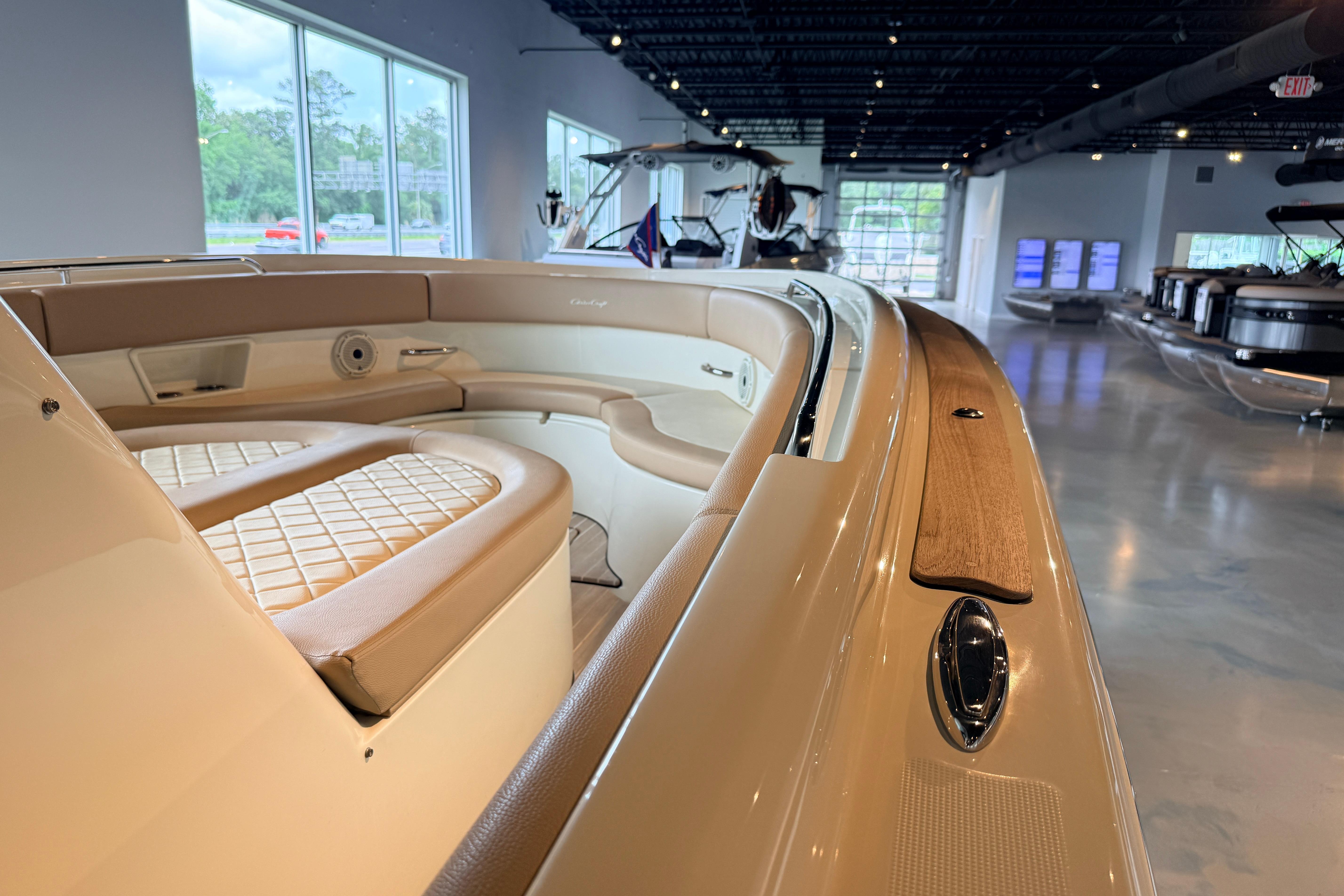 2024 Chris-Craft Catalina 30 interior showcasing luxurious seating and elegant design in showroom.