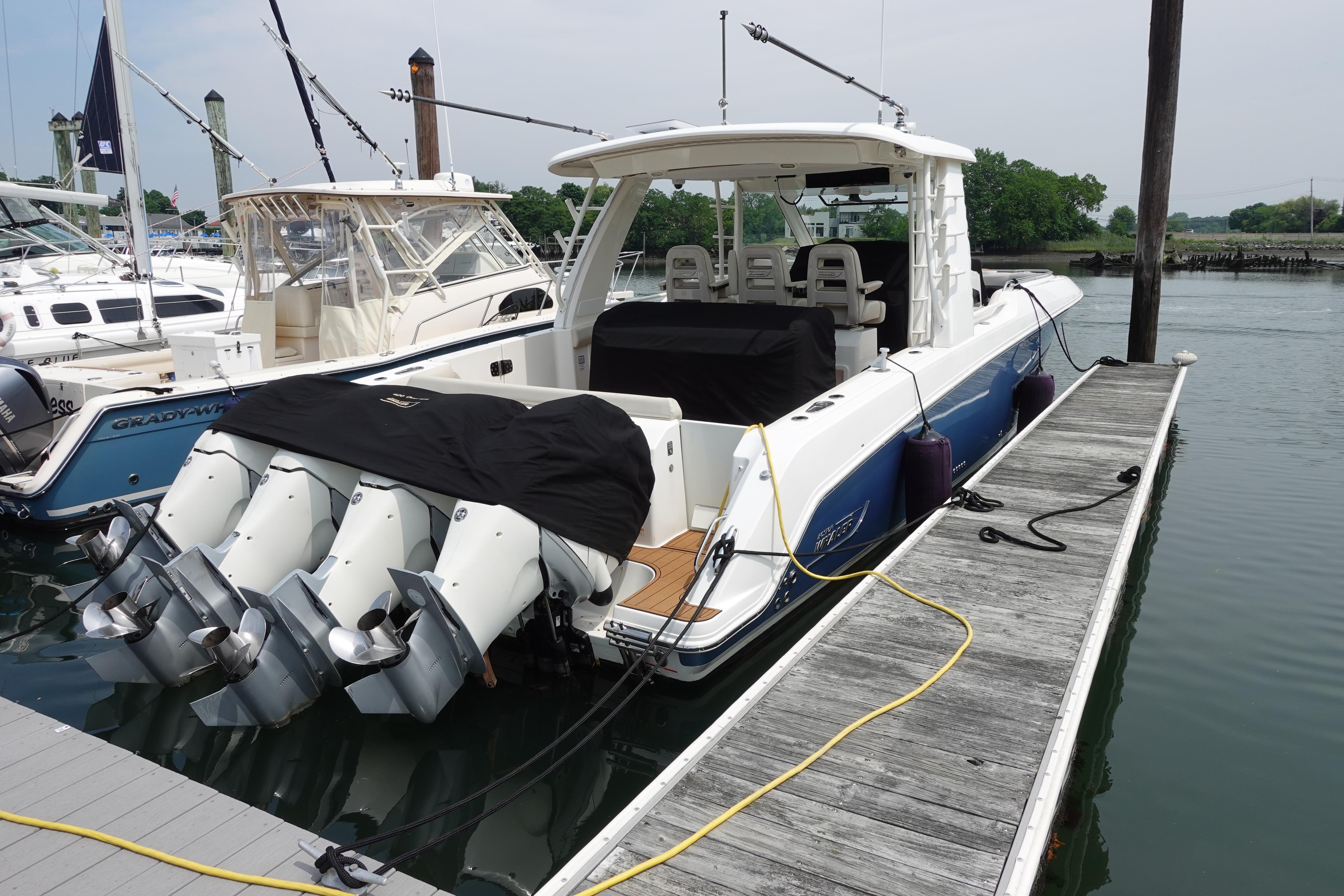 2020 Boston Whaler 420 Outrage docked, featuring multiple outboard engines.