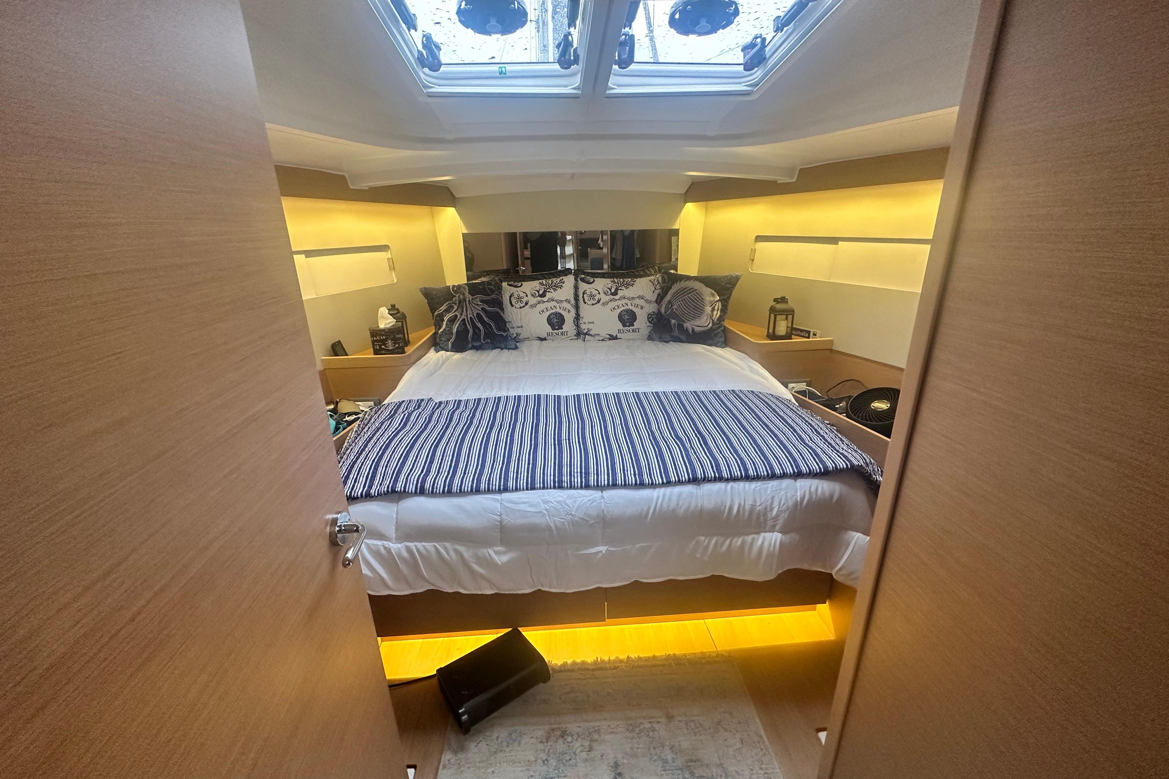 Luxurious cabin interior of 2020 Jeanneau Sun Odyssey 440 yacht with cozy bedding.