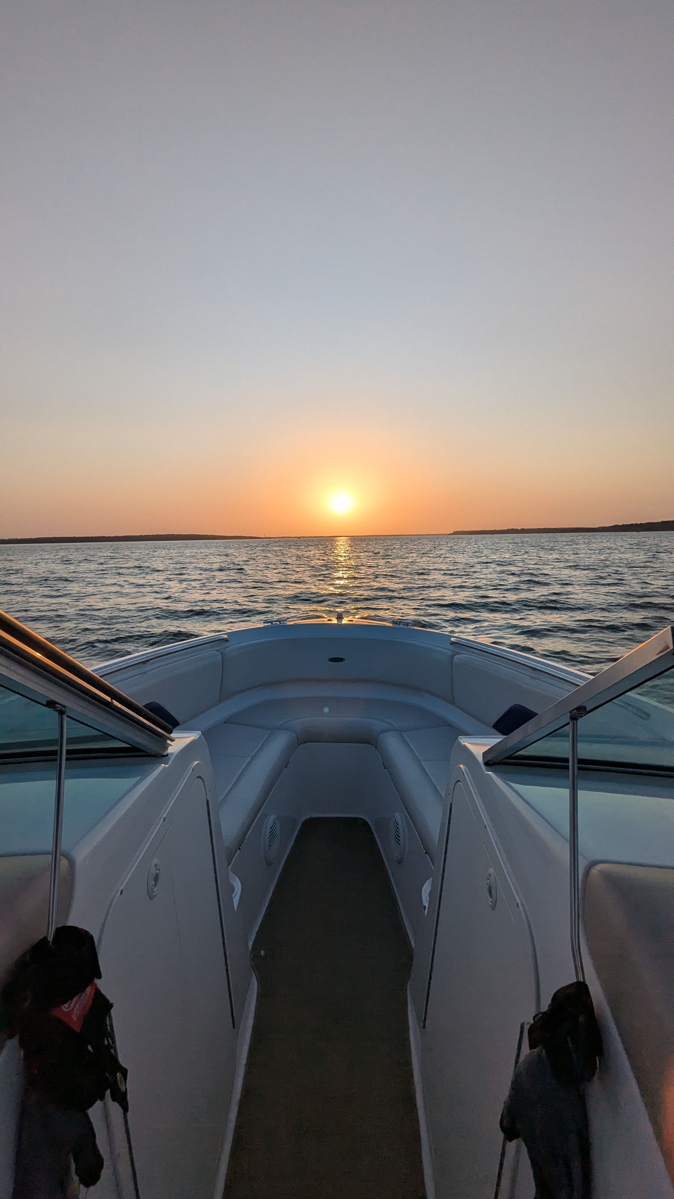 A 2000 Chaparral 240 SSi boat on the water at sunset.