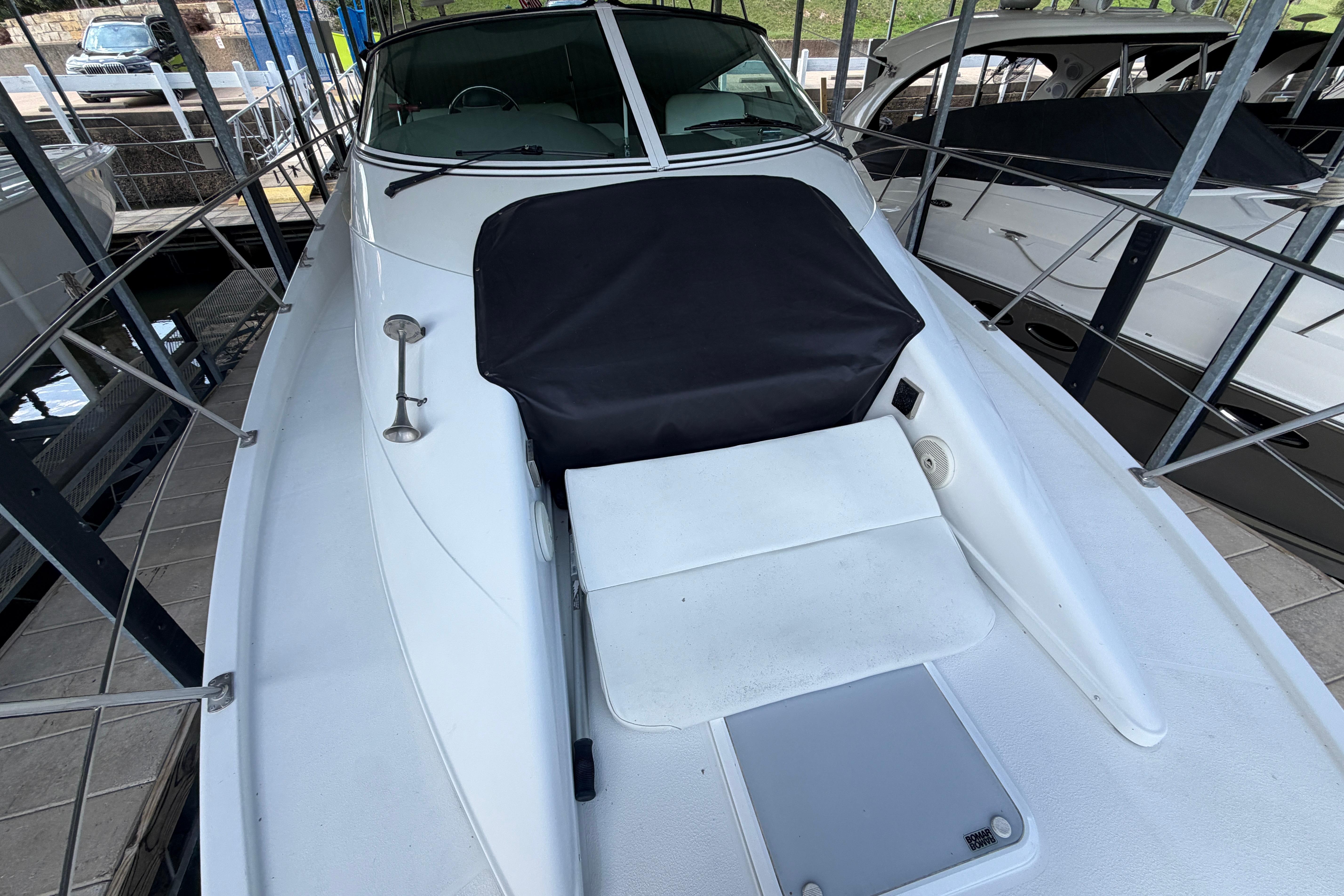 2000 Carver 350 Mariner yacht docked, showcasing sleek white deck design.