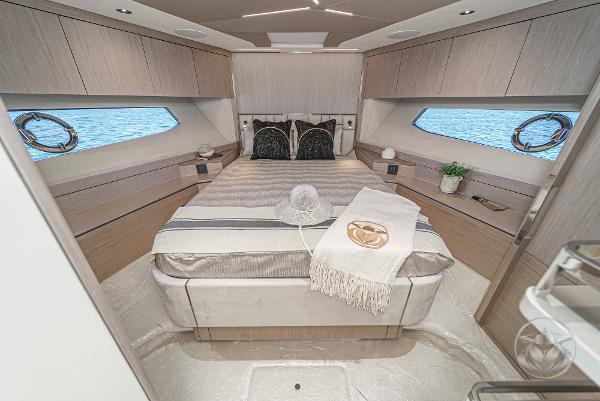 Luxurious cabin of the Sunseeker Manhattan 68 with a large bed and elegant decor.