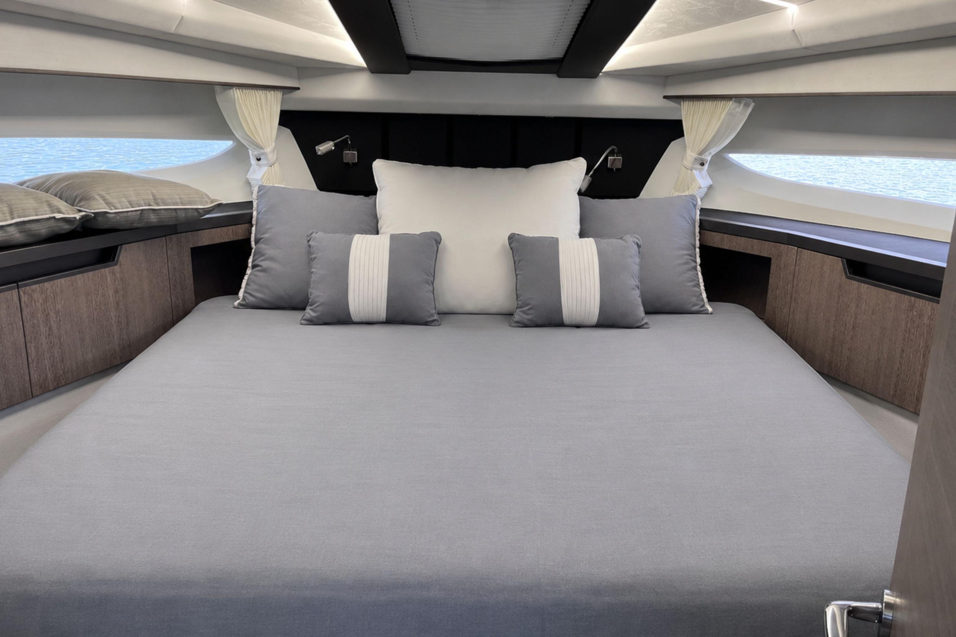 Luxurious bedroom interior of 2024 Galeon 425 HTS yacht with elegant bedding and modern design.
