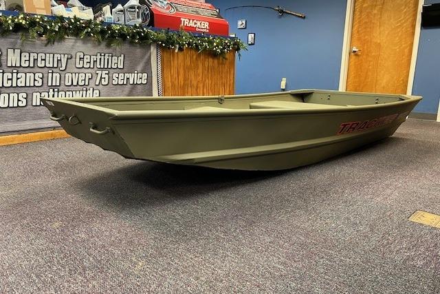 2026 Tracker Grizzly 10 Jon boat displayed indoors, with promotional banner in the background.