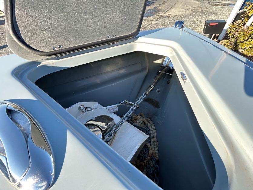 Open anchor compartment of 2024 Glasstream 32 GSX boat with chain and rope.