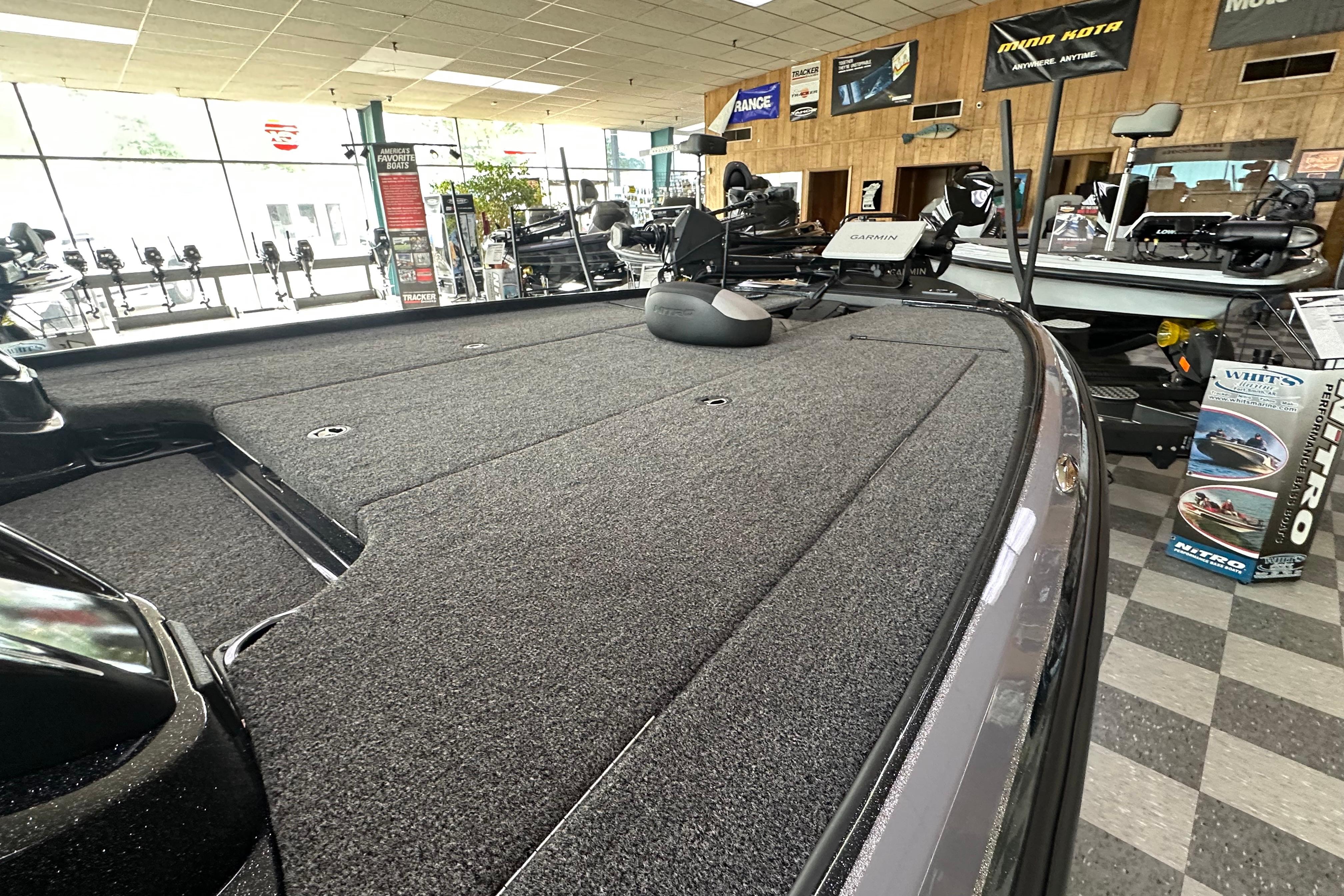 2025 Nitro Z20 XL Pro boat interior with carpeted deck in showroom.