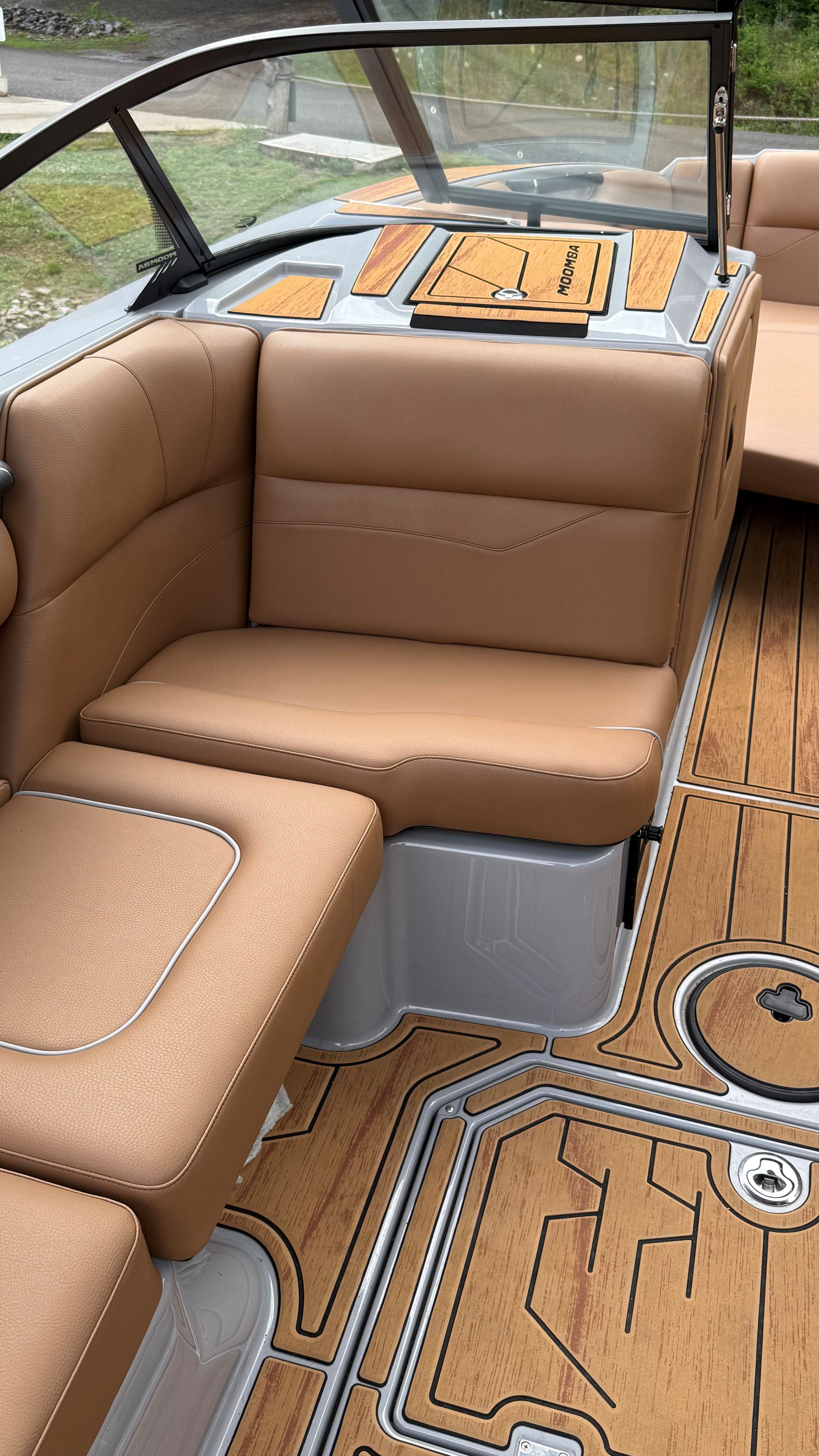 Interior of a 2025 Malibu Mojo with brown leather seats and wood flooring.
