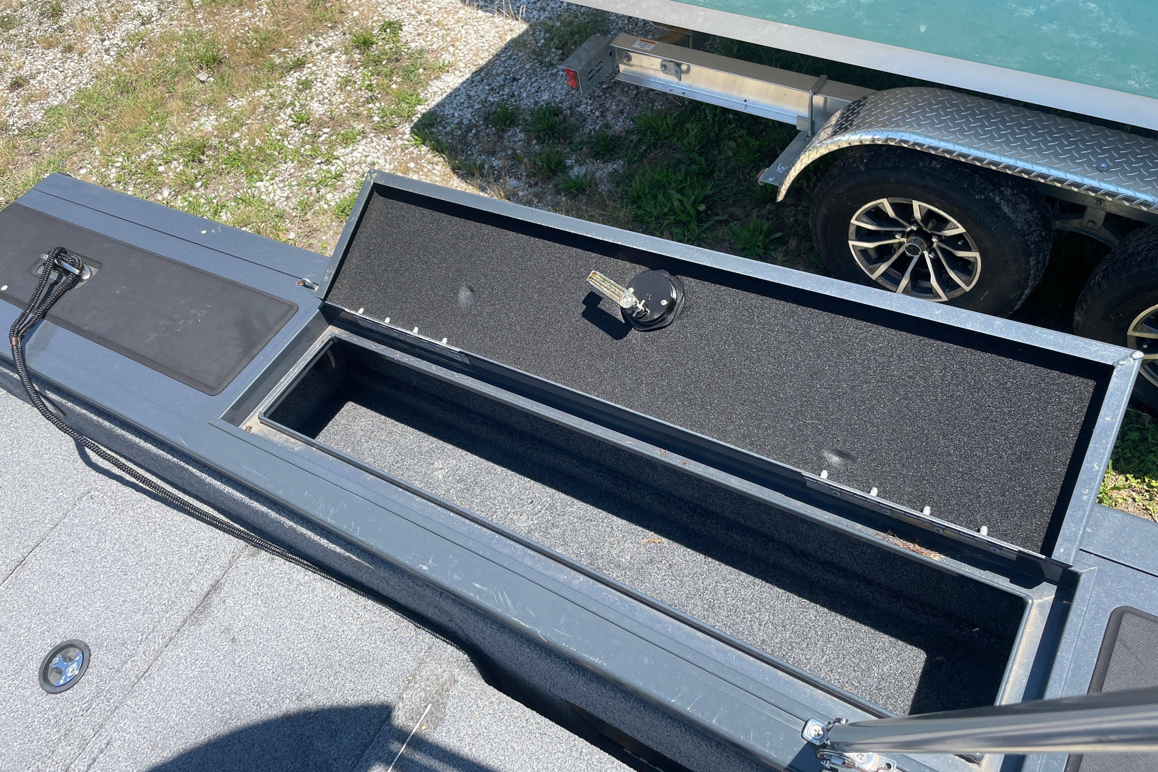 Open storage compartment on 2022 Tracker Targa V-18 WT boat, showing interior space.