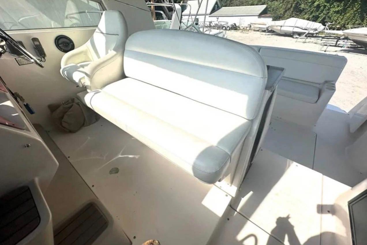 2004 Rinker Fiesta Vee 410 boat interior with white seating and steering area.