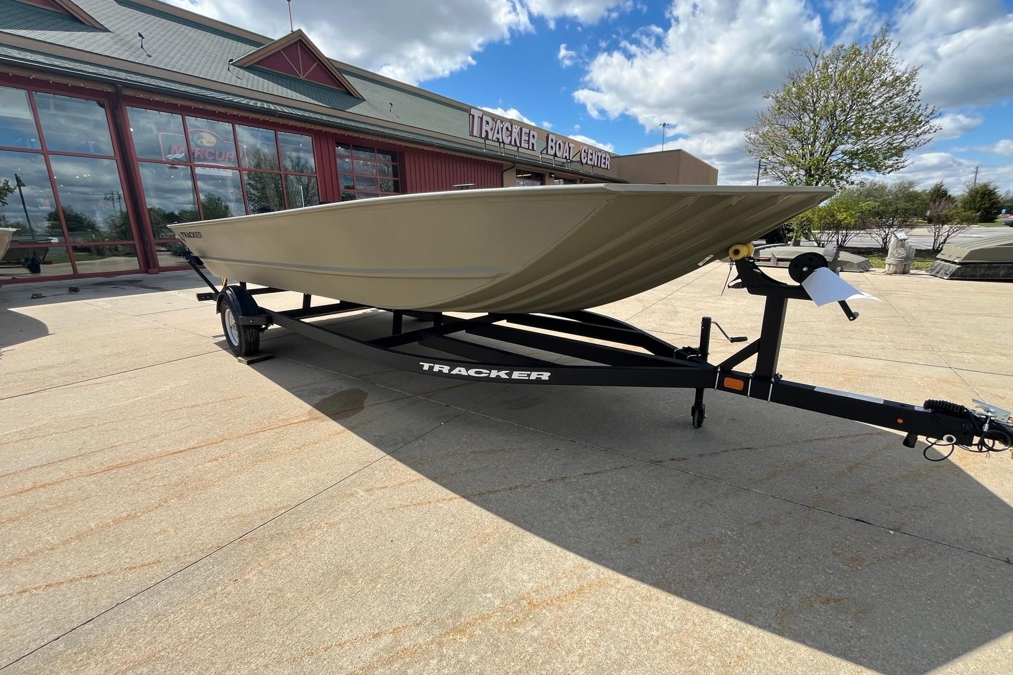 2026 Tracker Grizzly 2072 Utility boat on trailer at dealership under blue sky.