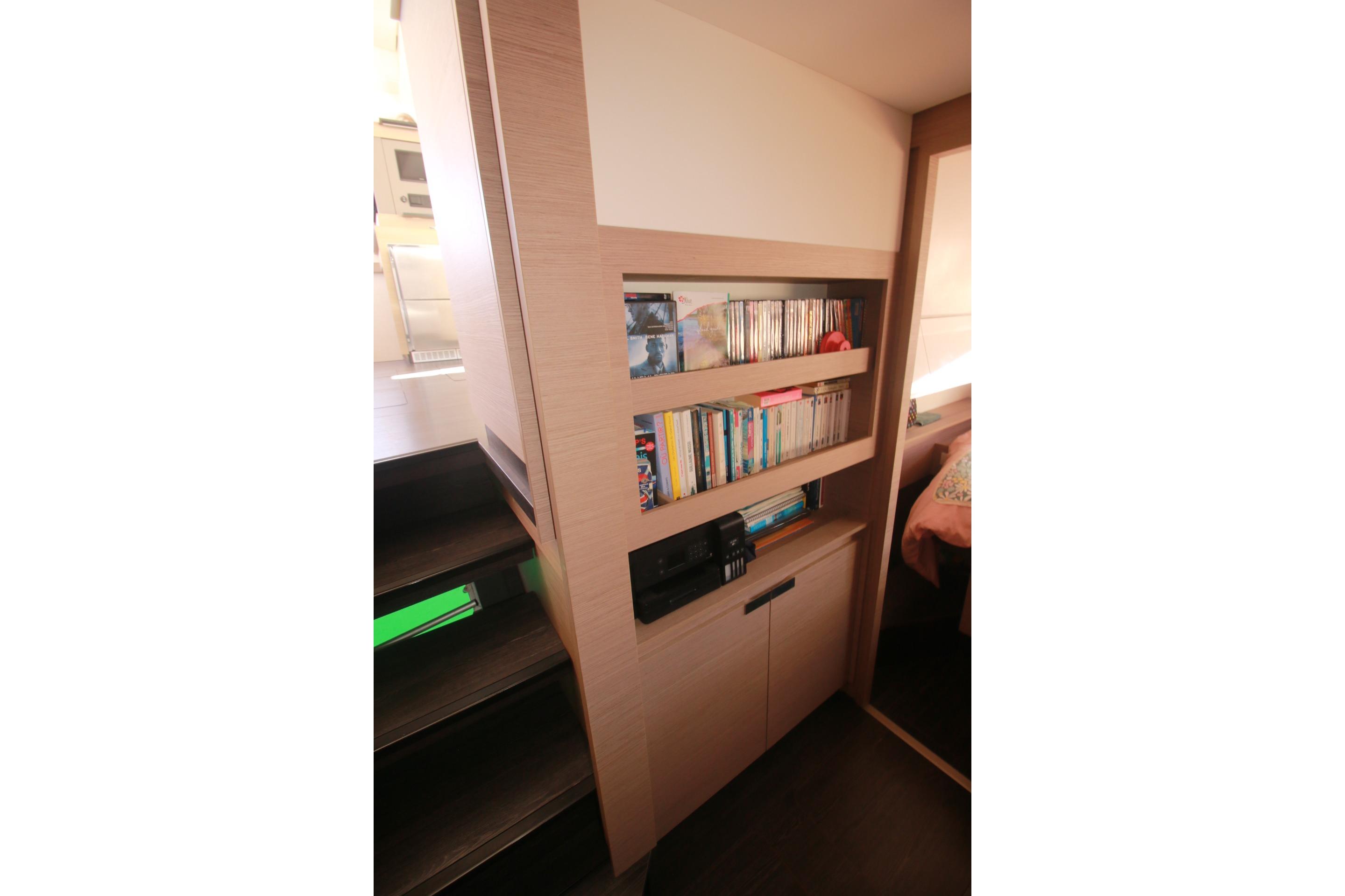 Interior of 2022 Fountaine Pajot Elba 45 Catamaran with built-in bookshelf and storage.