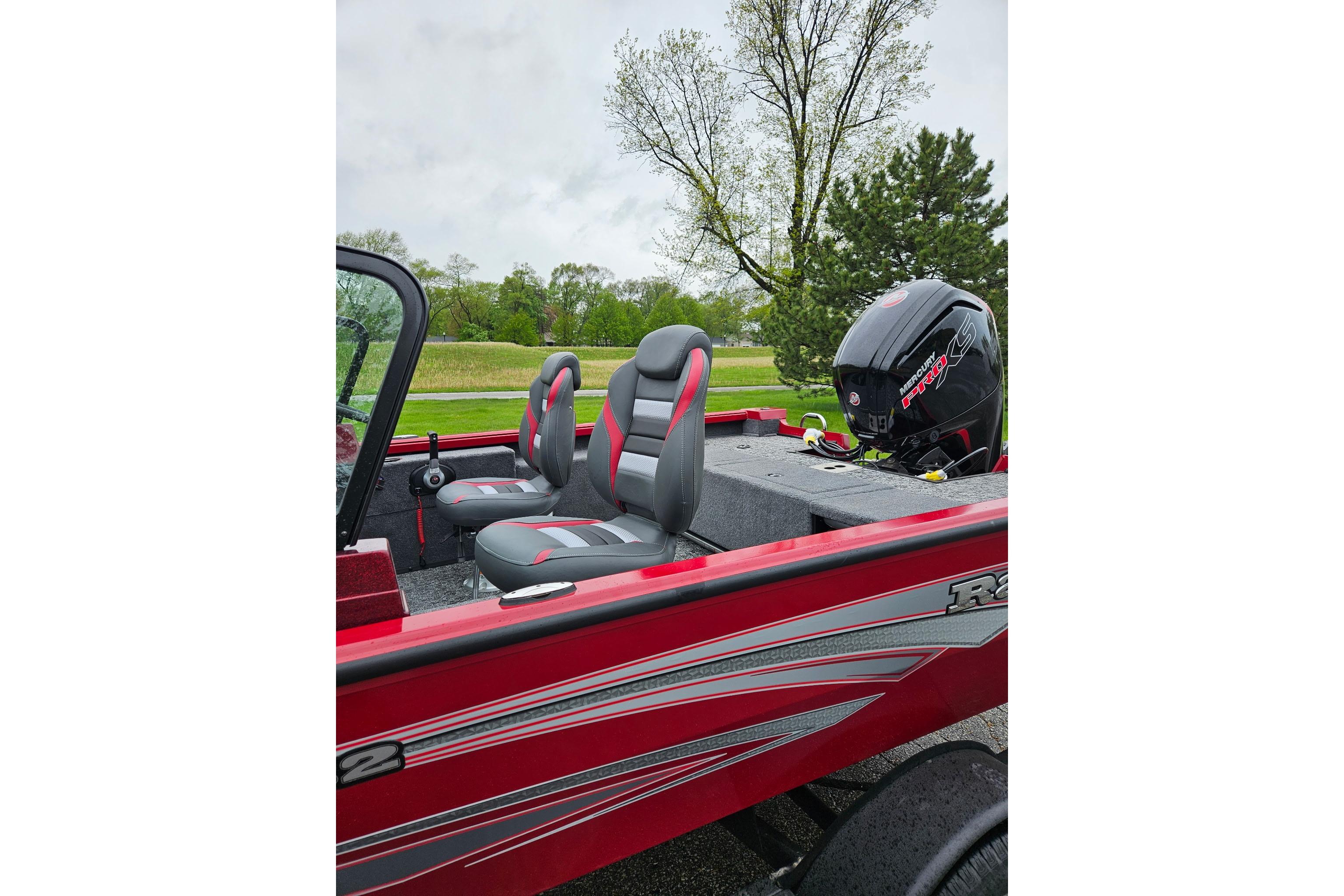 2026 Ranger VS1782SC Reata boat interior with seats and motor, set in a scenic outdoor location.