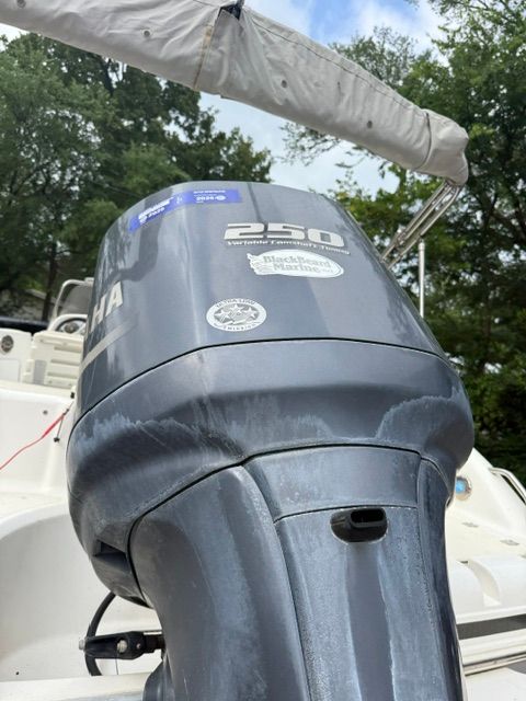 A gray outboard motor labeled "250" is attached to a boat.