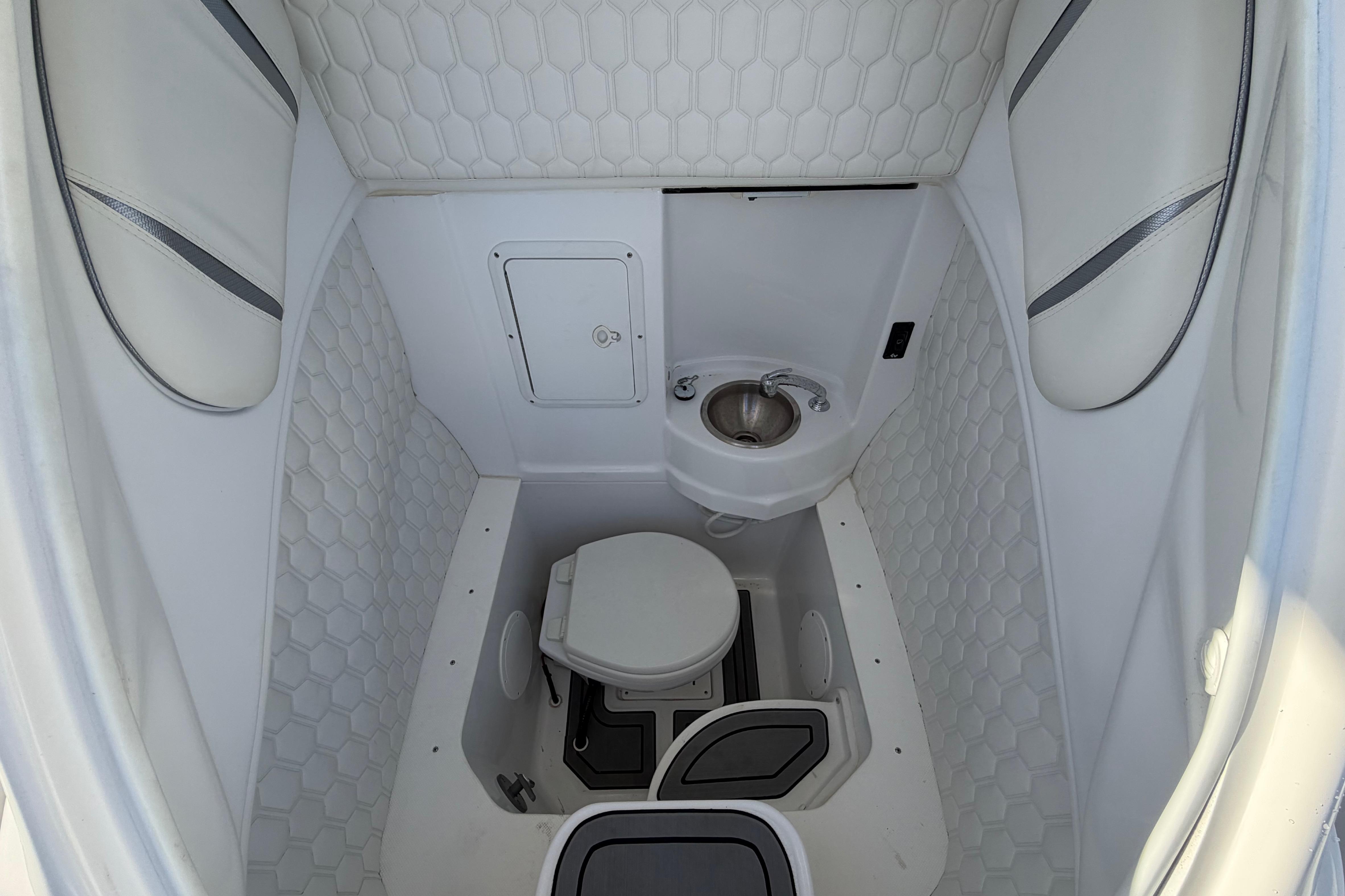 2022 Glasstream 328 Pro-XS boat interior with compact bathroom and sink.
